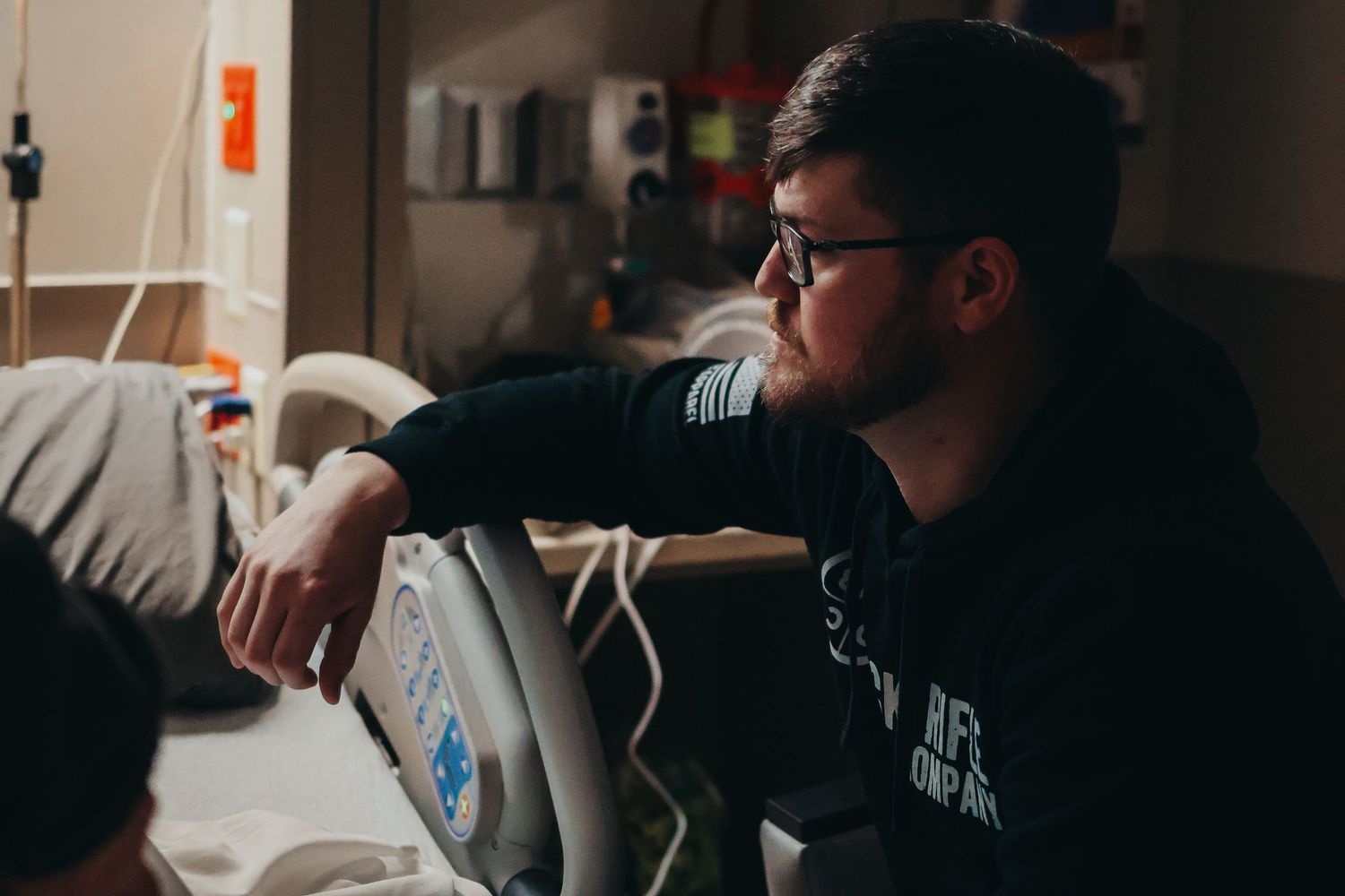Medical team working together in a darkened hospital environment.