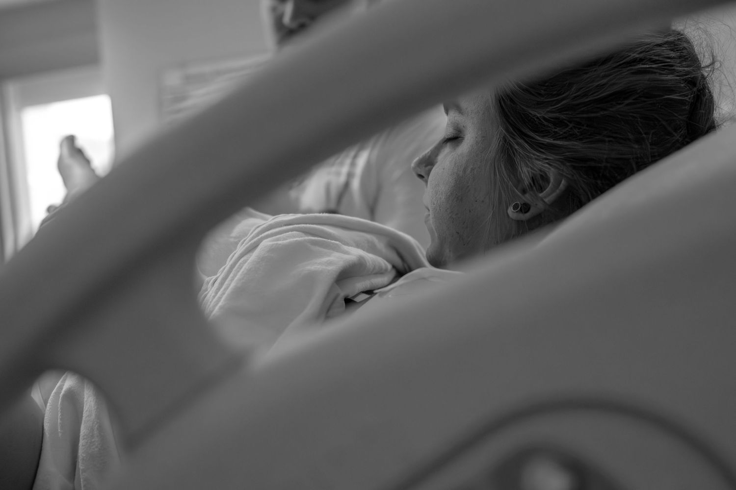 Blurred view through medical equipment in a hospital setting.