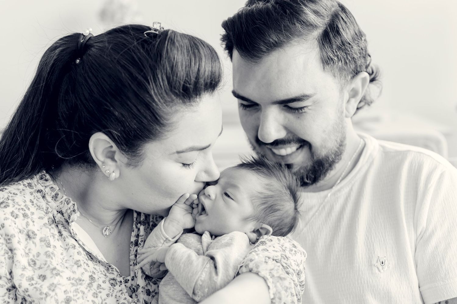 Black and white intimate family portrait with newborn baby.