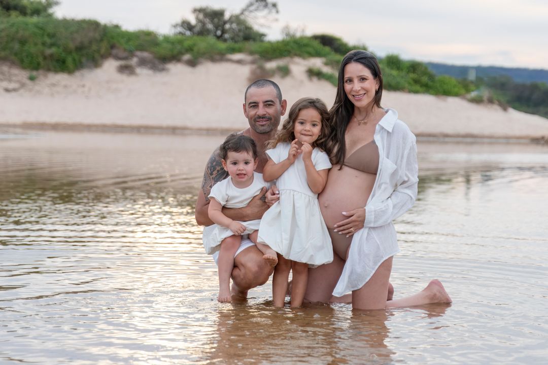 Family portrait session at a scenic lakeside location during golden hour.