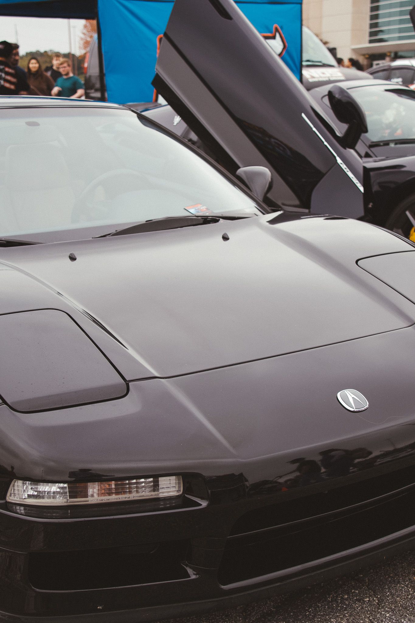 Black NSX sports car with pop-up headlights photographed from front quarter angle.