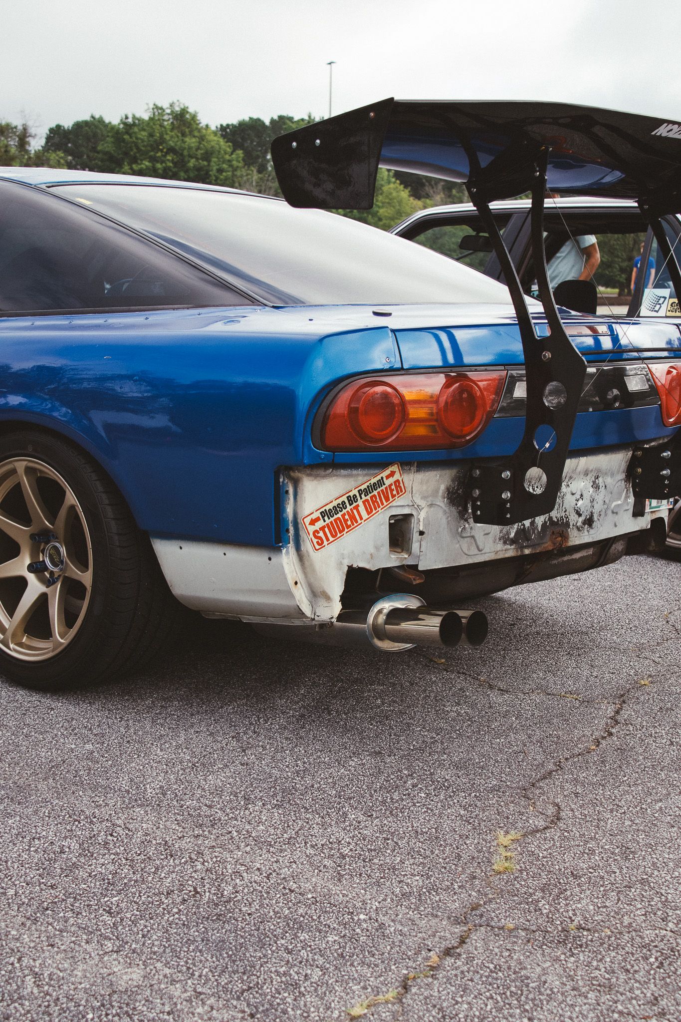 Blue Nissan Skyline with exposed rear diffuser and modified tail lights.