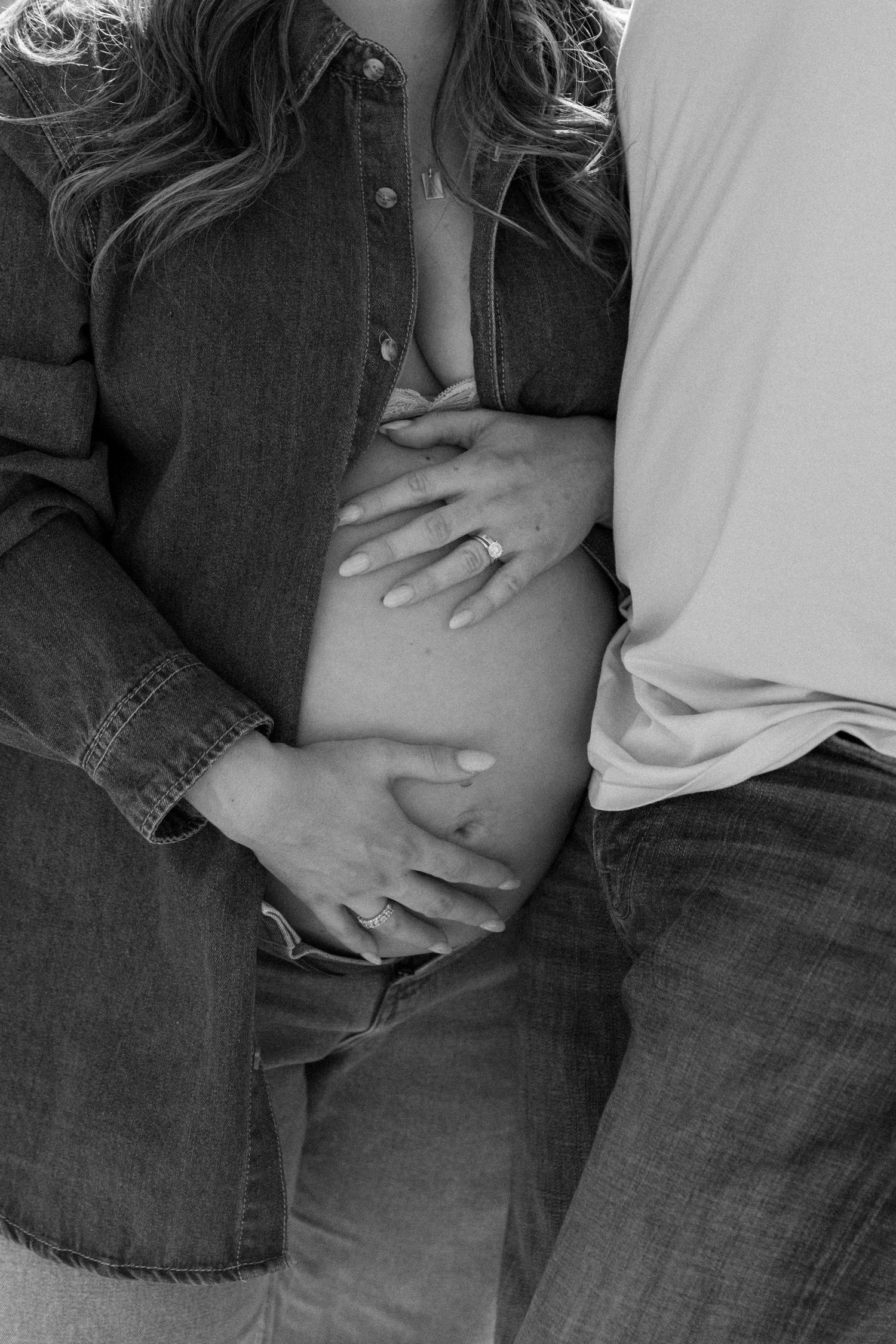 A series of black and white photos showing hands resting on denim-clad legs in an intimate pose.