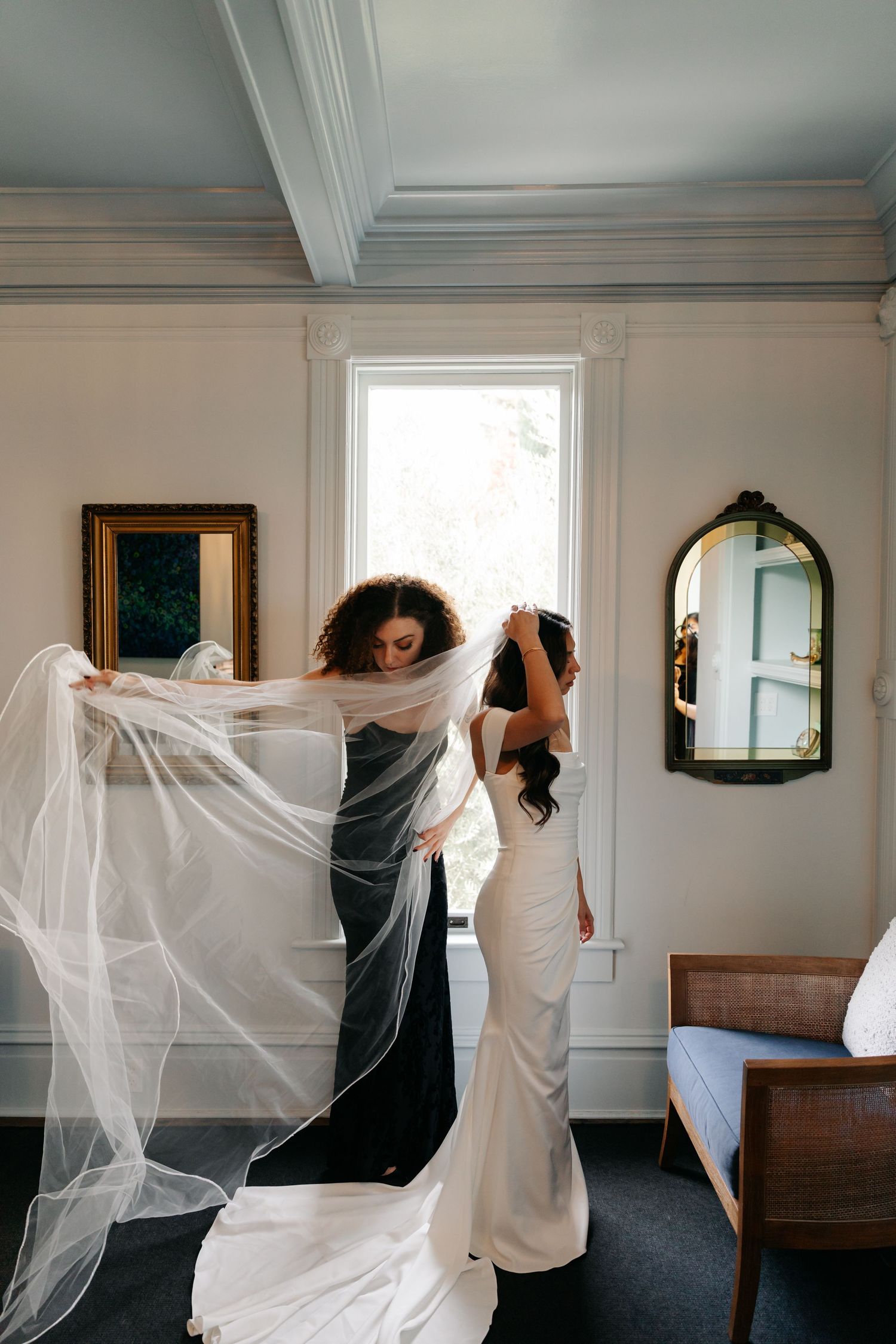 A sequence of artistic photos showing flowing white fabric being moved against a minimalist interior wall with windows.