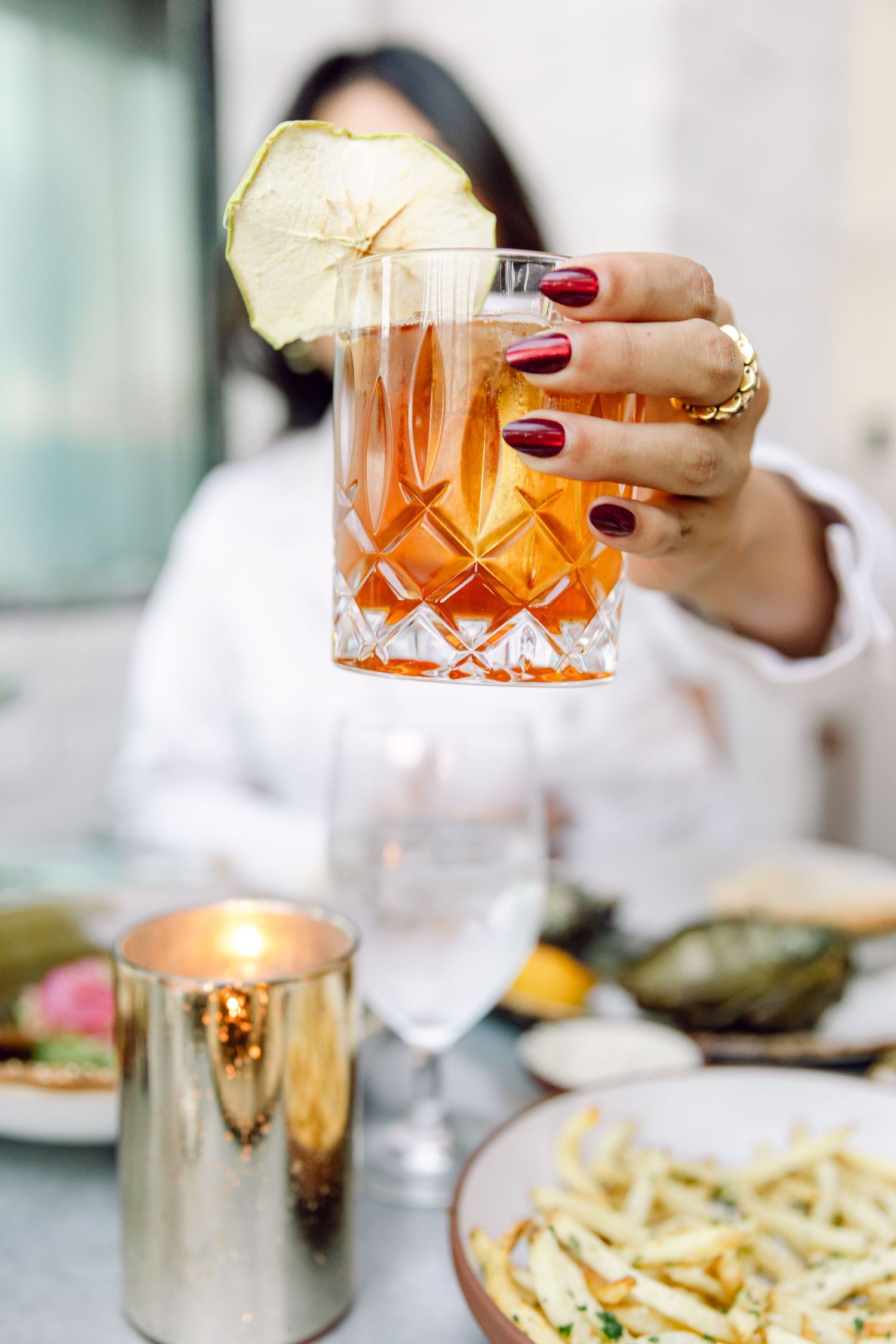 Crafted cocktail in a crystal glass garnished with a fresh citrus wheel.