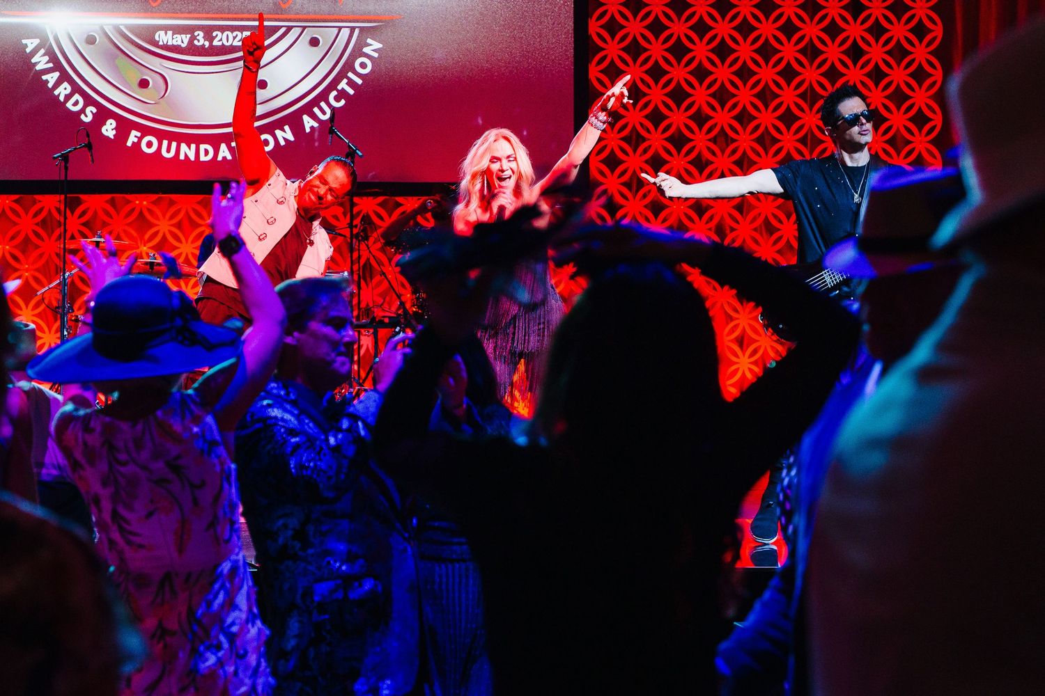 Energetic dance performance with colorful red and blue stage lighting effects.