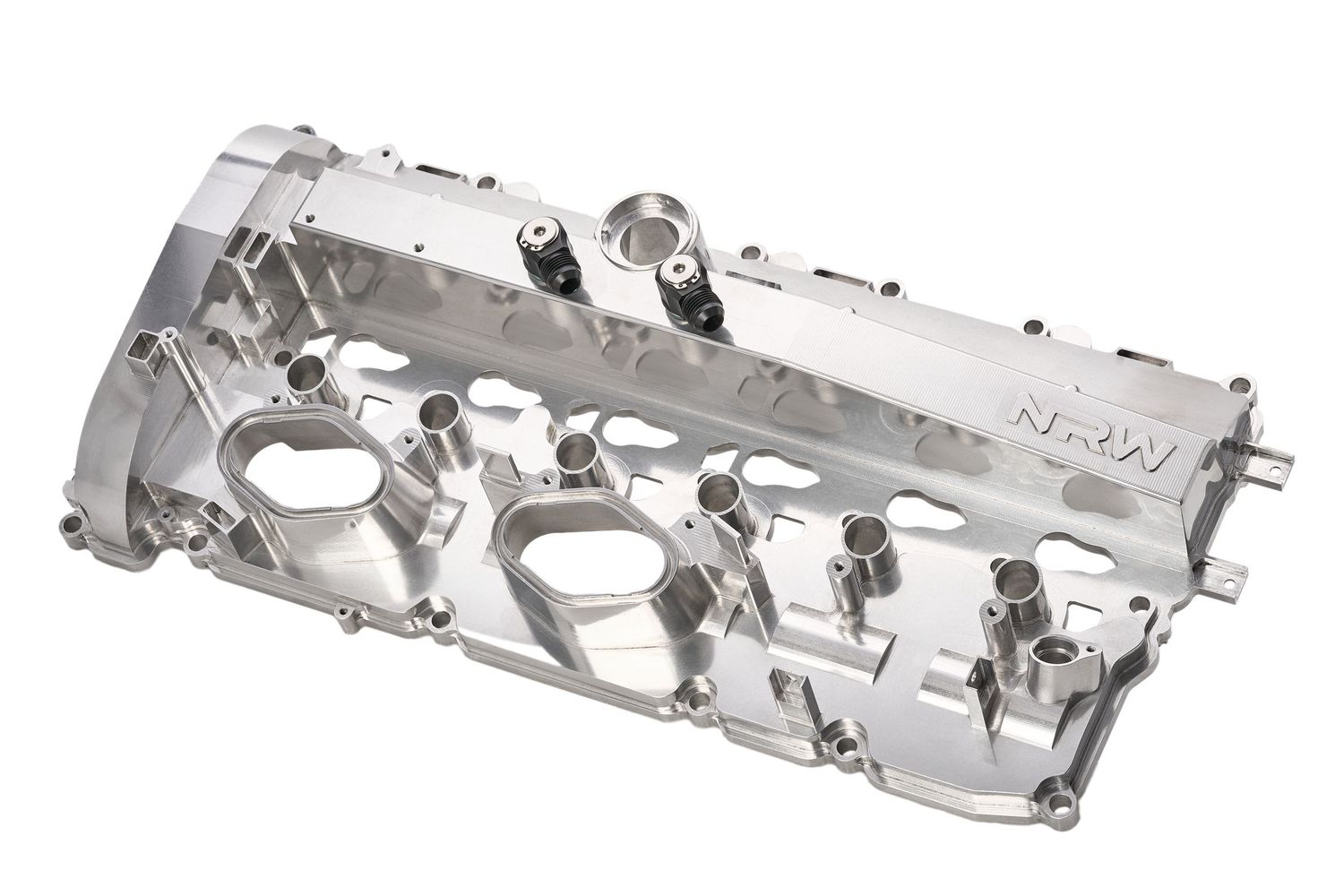 Four silver aluminum automotive cylinder head valve covers arranged in a horizontal line on a white surface.