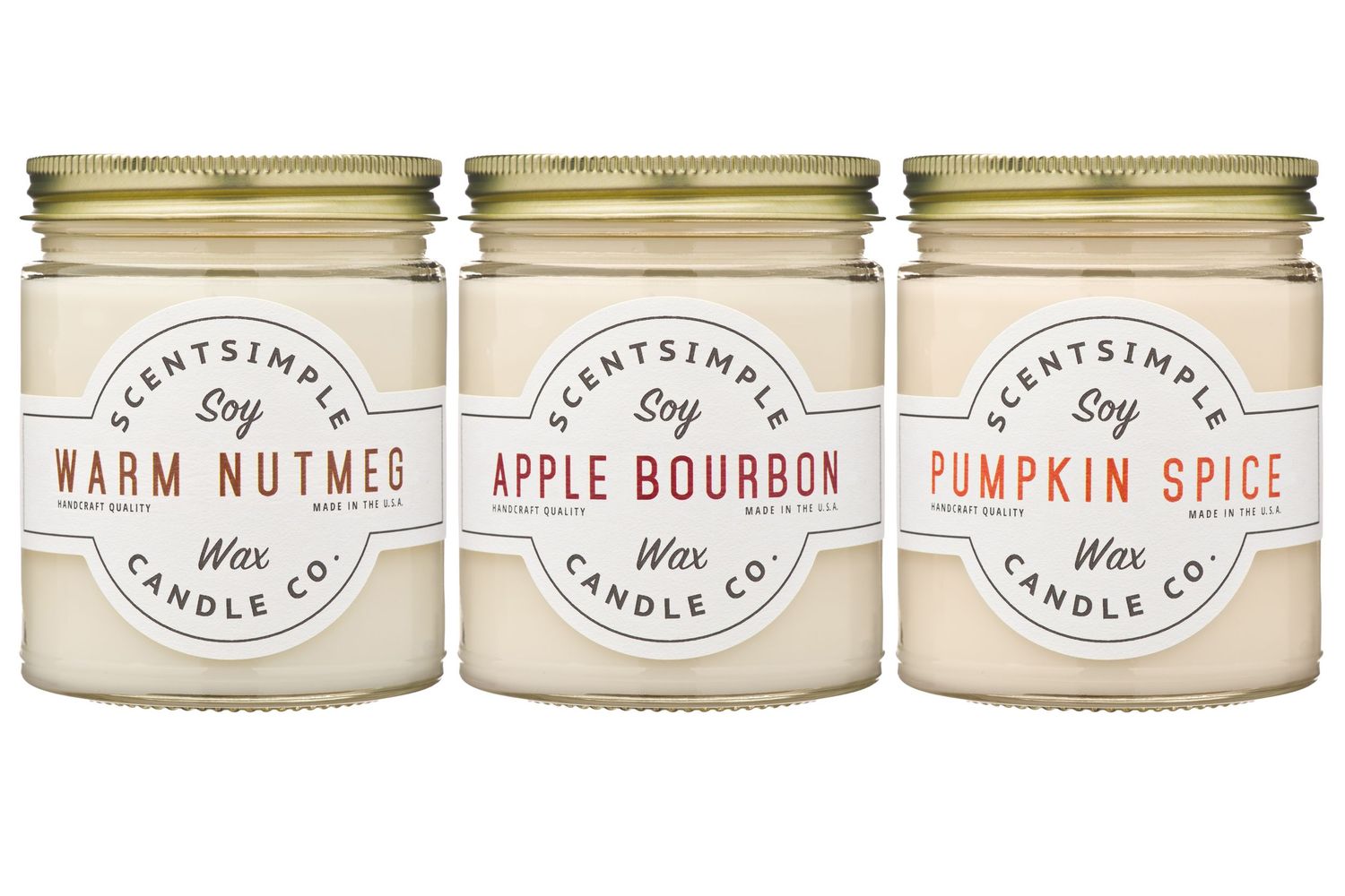 Nine identical white glass mason jar candles with kraft paper labels and gold lids arranged in three rows.