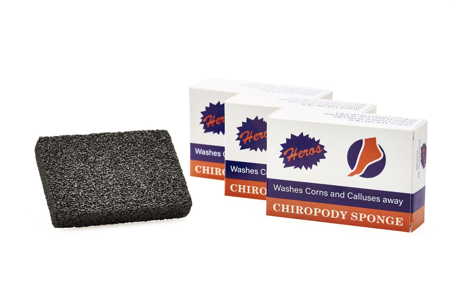 Three boxes of charcoal-colored chiropody sponges used for cleaning and callus removal with one sponge displayed.