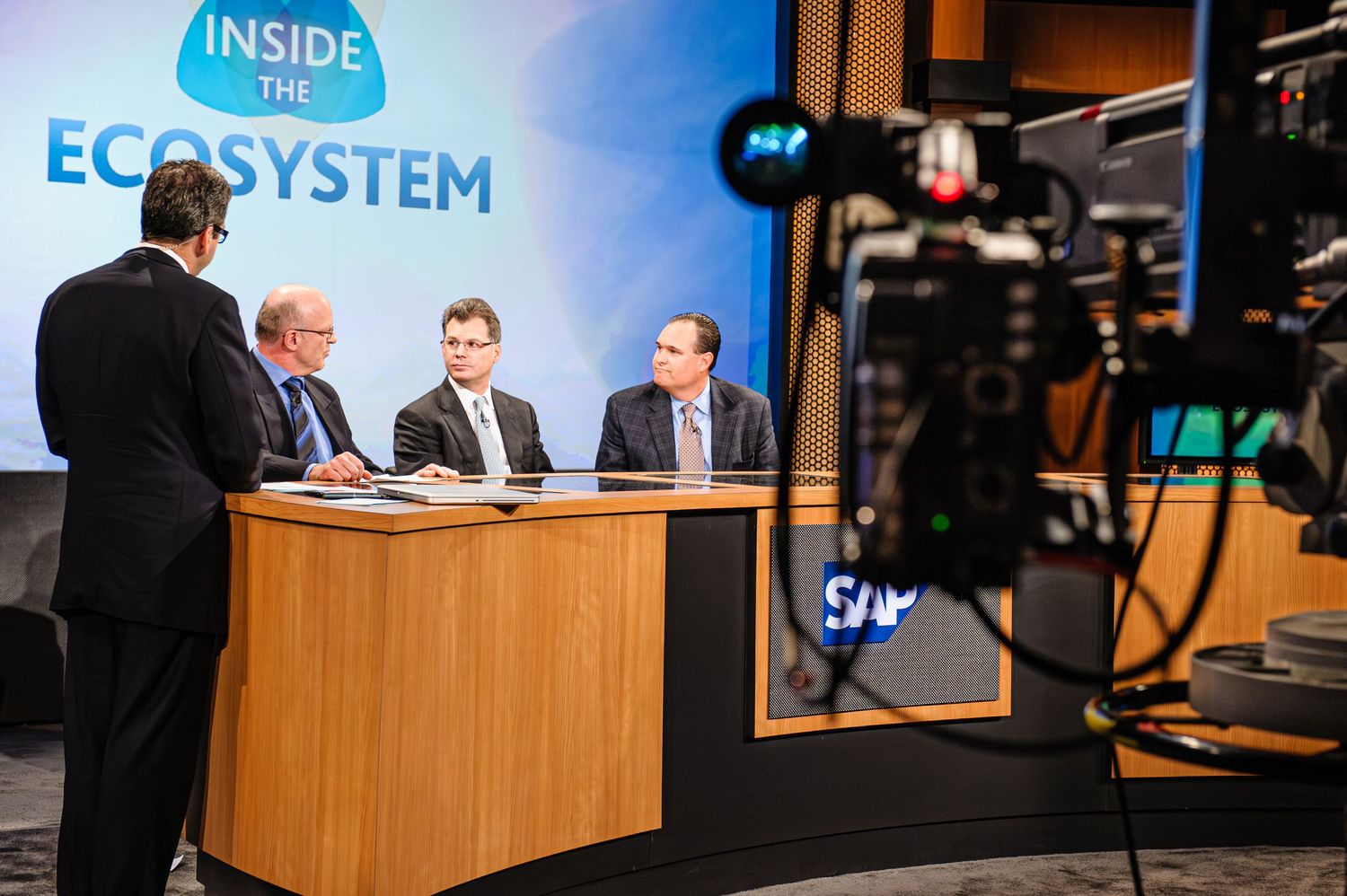 Television studio set featuring panel discussion for Inside Ecosystem program.
