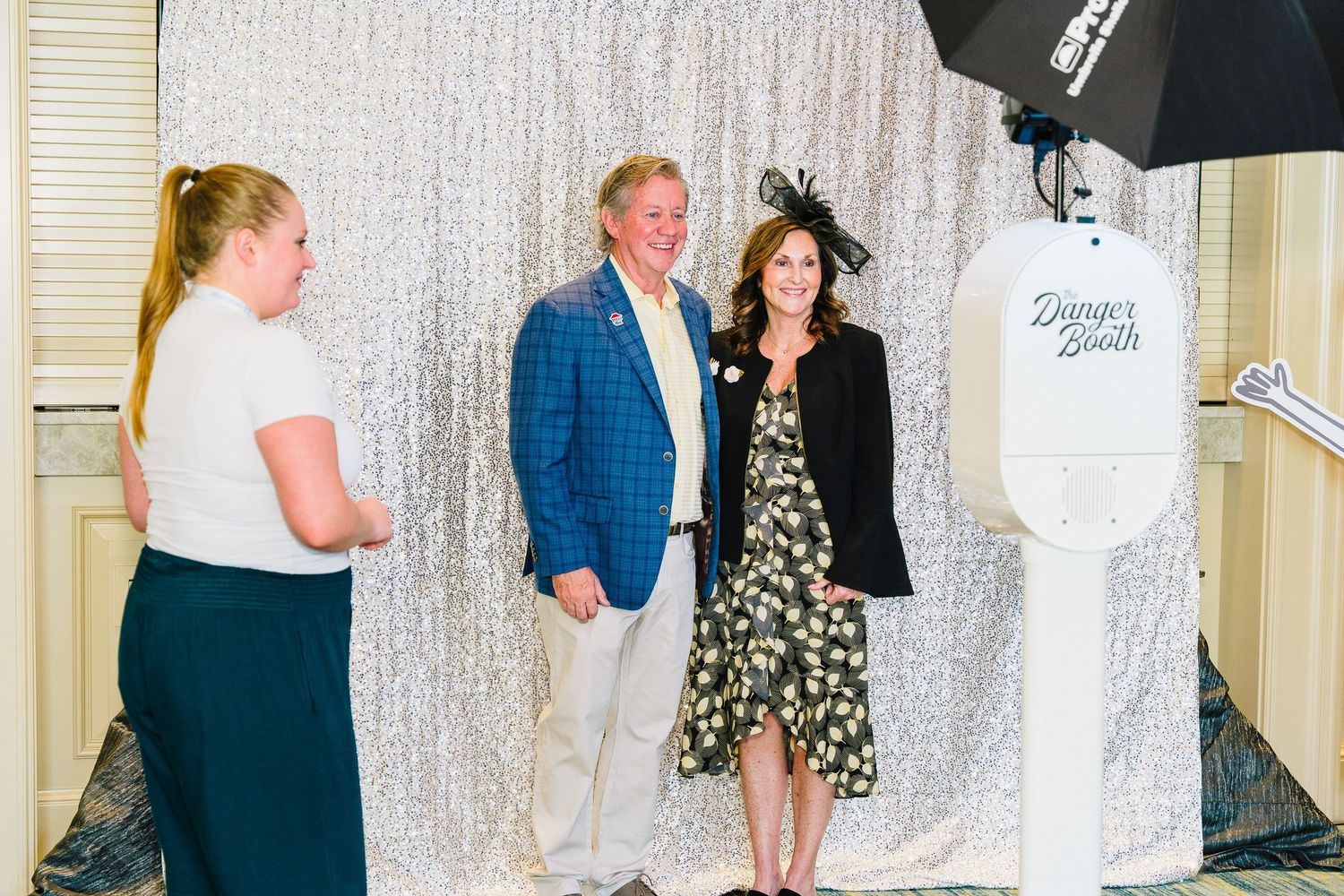 Professional photo setup with silver sequin backdrop and studio lighting equipment.