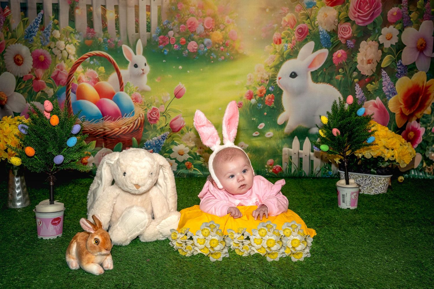 Adorable Easter scene with bunnies, colorful eggs, spring flowers, and pastel decorations in a garden setting.