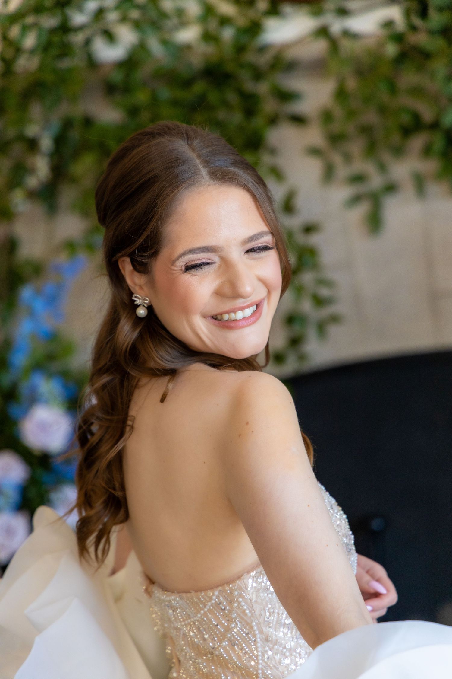 Close-up bridal portrait showcasing strapless lace wedding dress and romantic styling.