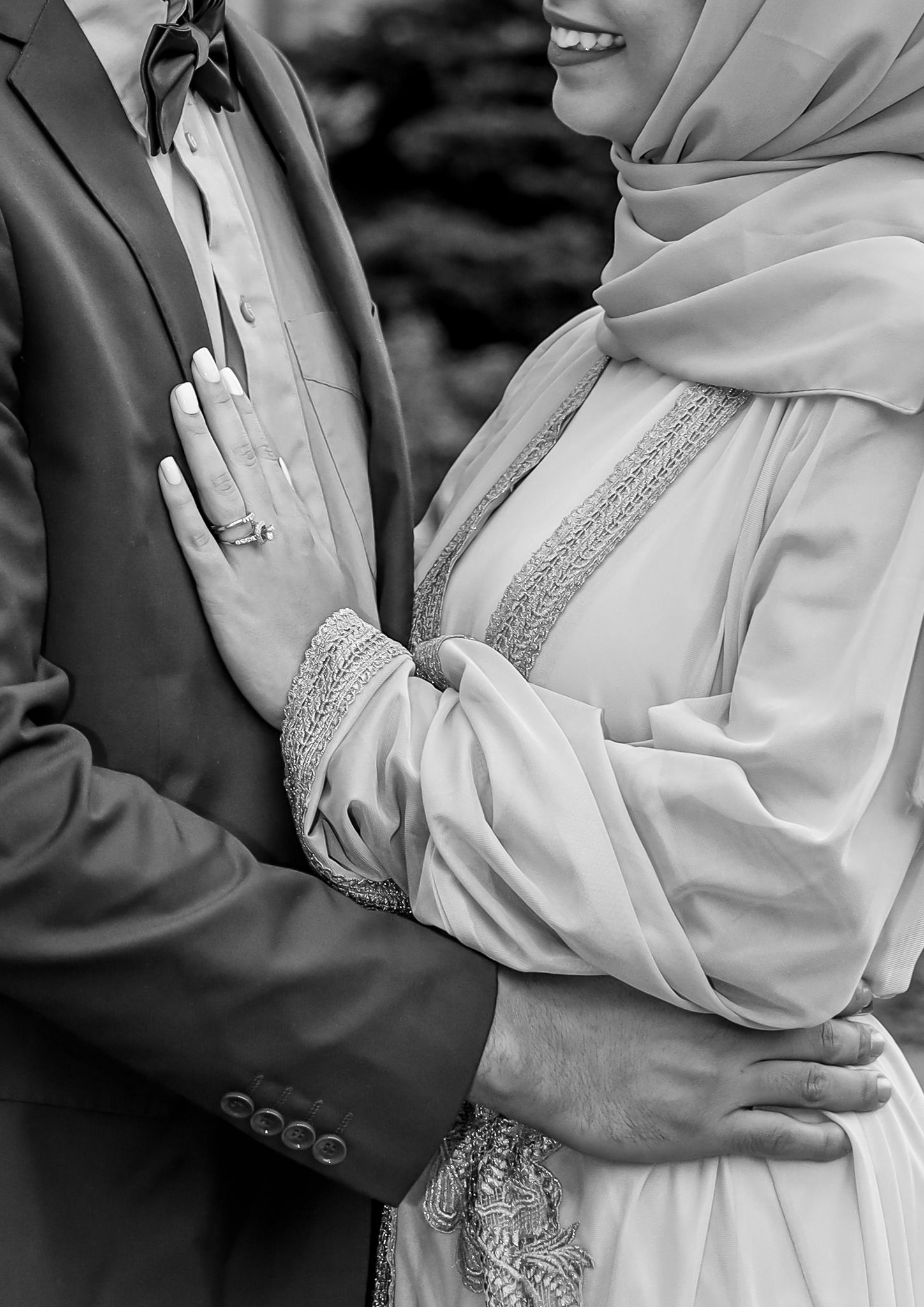 Close-up of traditional hijab wedding attire with embellished details in black and white.