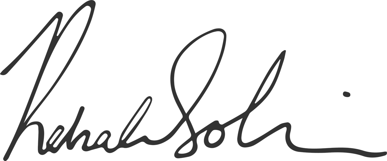 A black handwritten signature with flowing cursive letters appears against a white background.