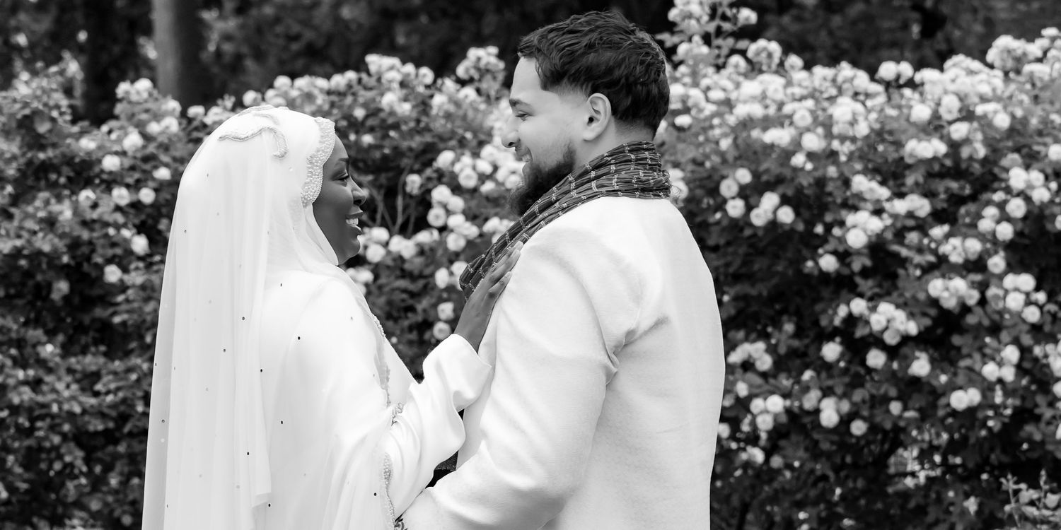 A series of black and white wedding photos captures intimate moments between a couple among blooming rose bushes. | PHL, PA Wedding