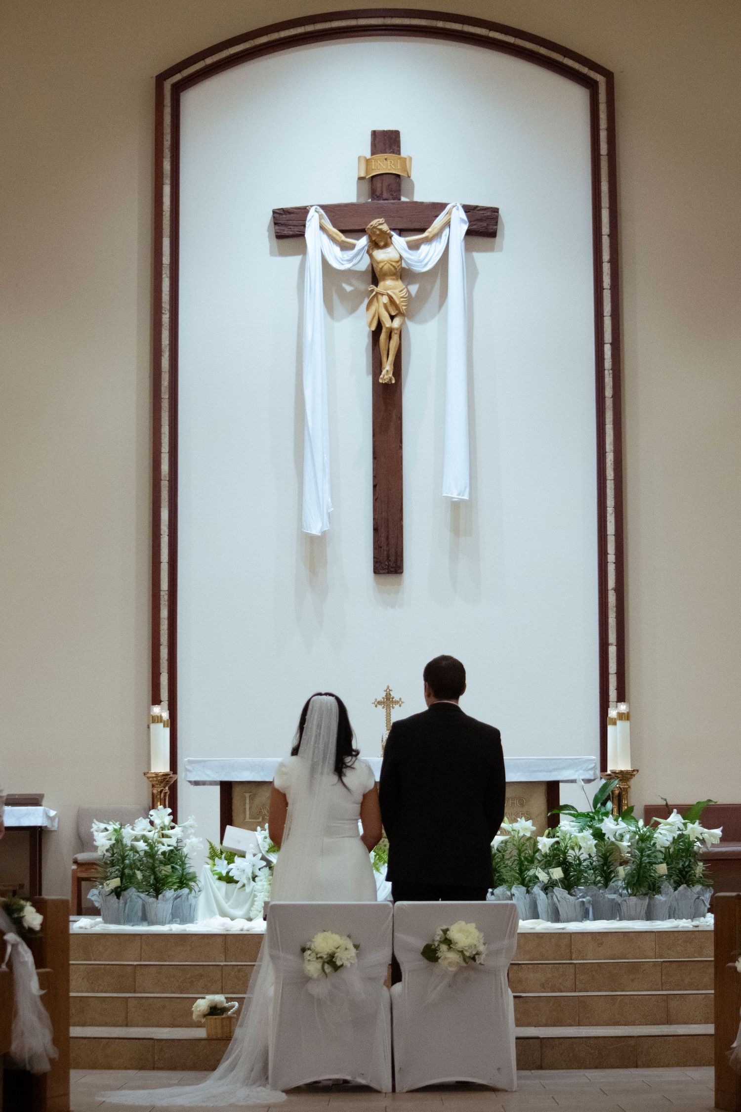 Interior sequence of church altar area showing progression of wooden crucifix and white fabric draping across multiple frames.
