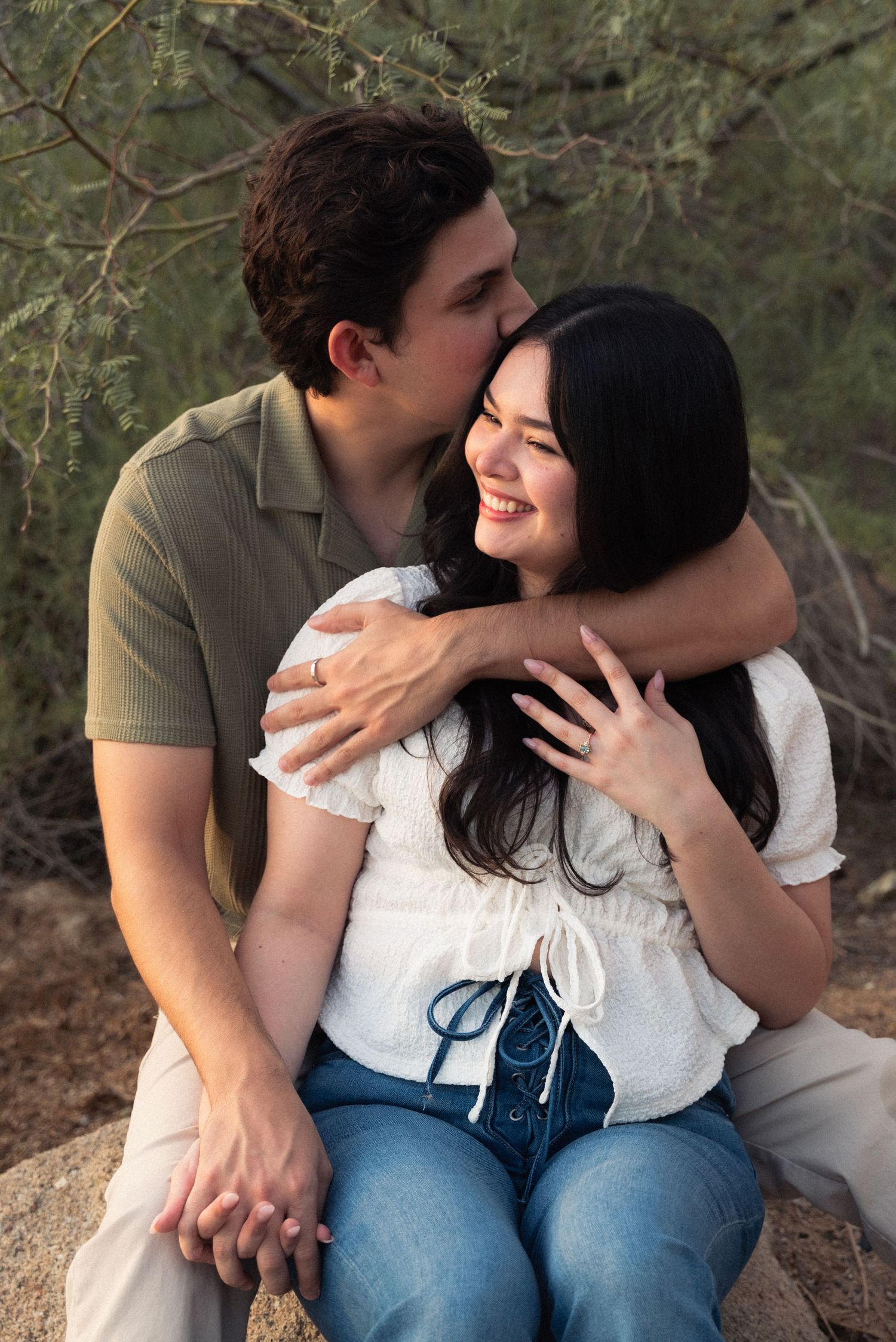 A couple sitting together outdoors shares intimate moments of laughter and affection in a progressive sequence of photos.