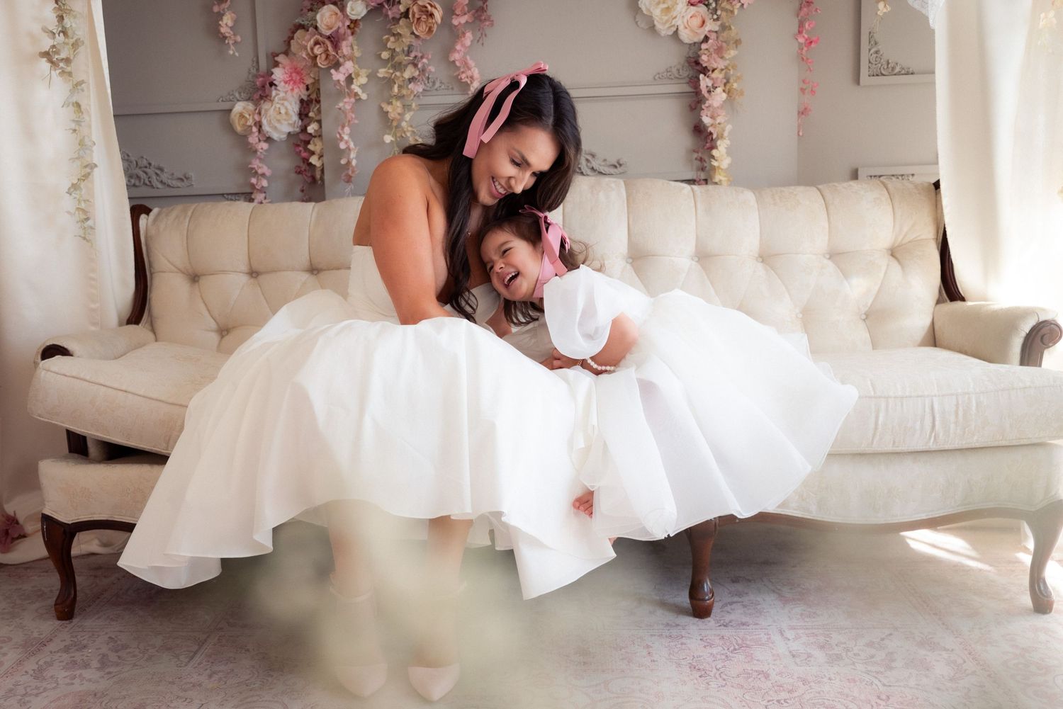 A series of photos showing a person in a white wedding dress sitting and posing on a cream-colored sofa.