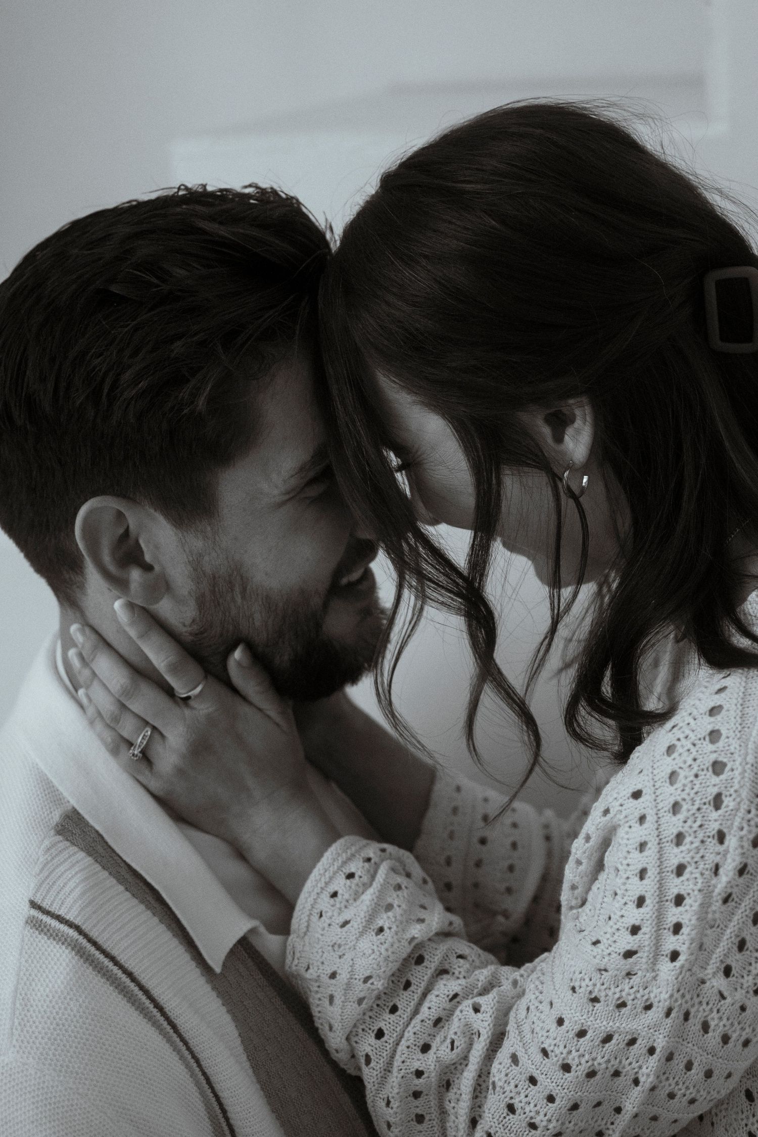 Intimate black and white portrait of couple sharing romantic moment.