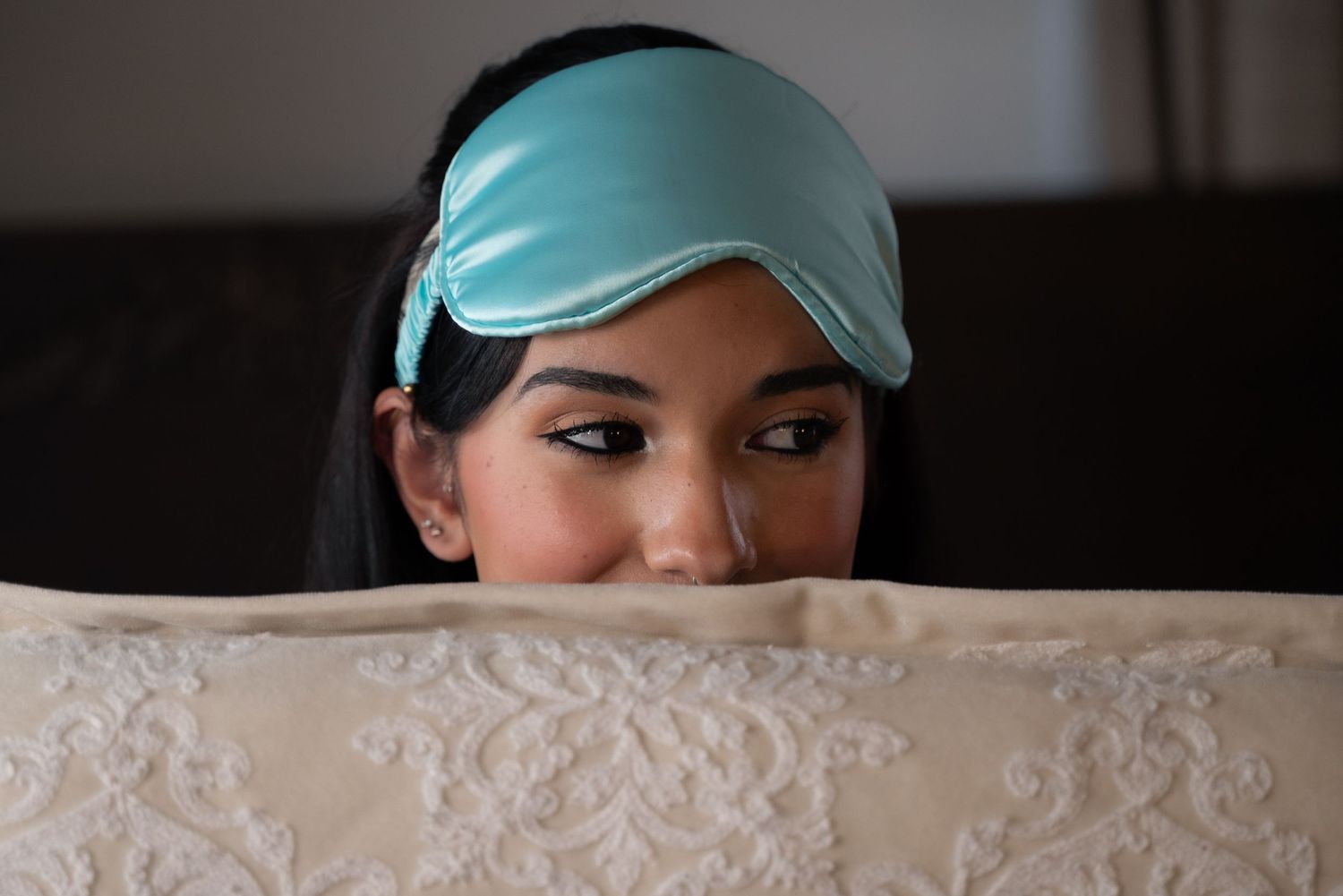 A series of headshots showing someone wearing a mint green baseball cap in different poses.