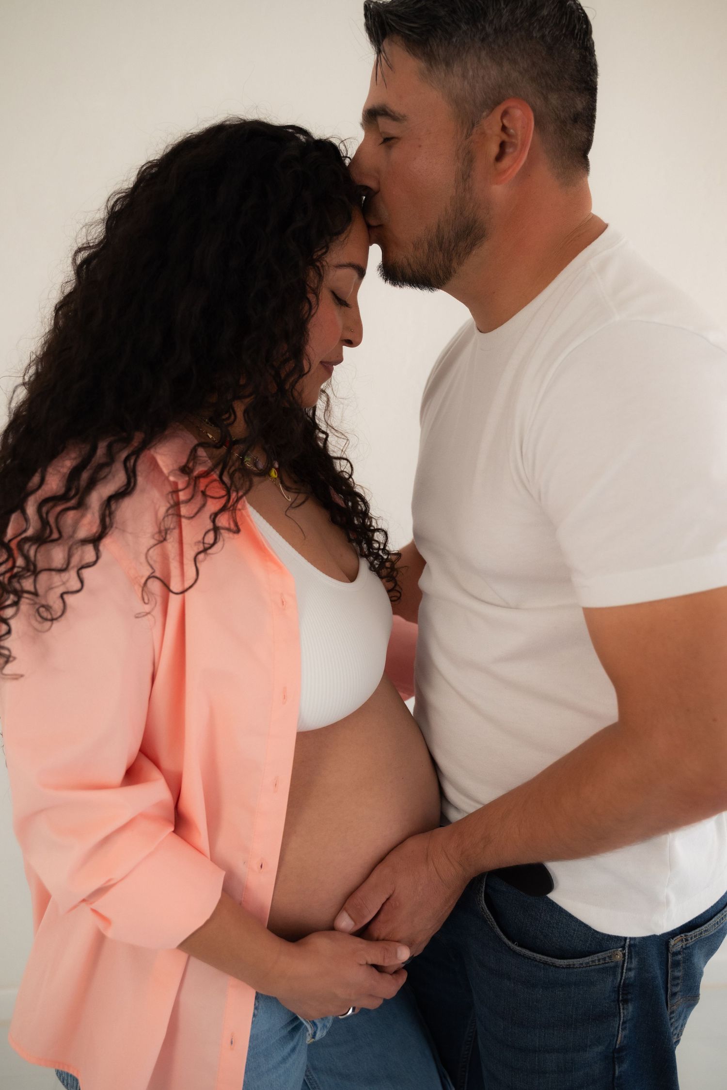 Intimate couple poses showing affection in series of romantic shots against neutral background.