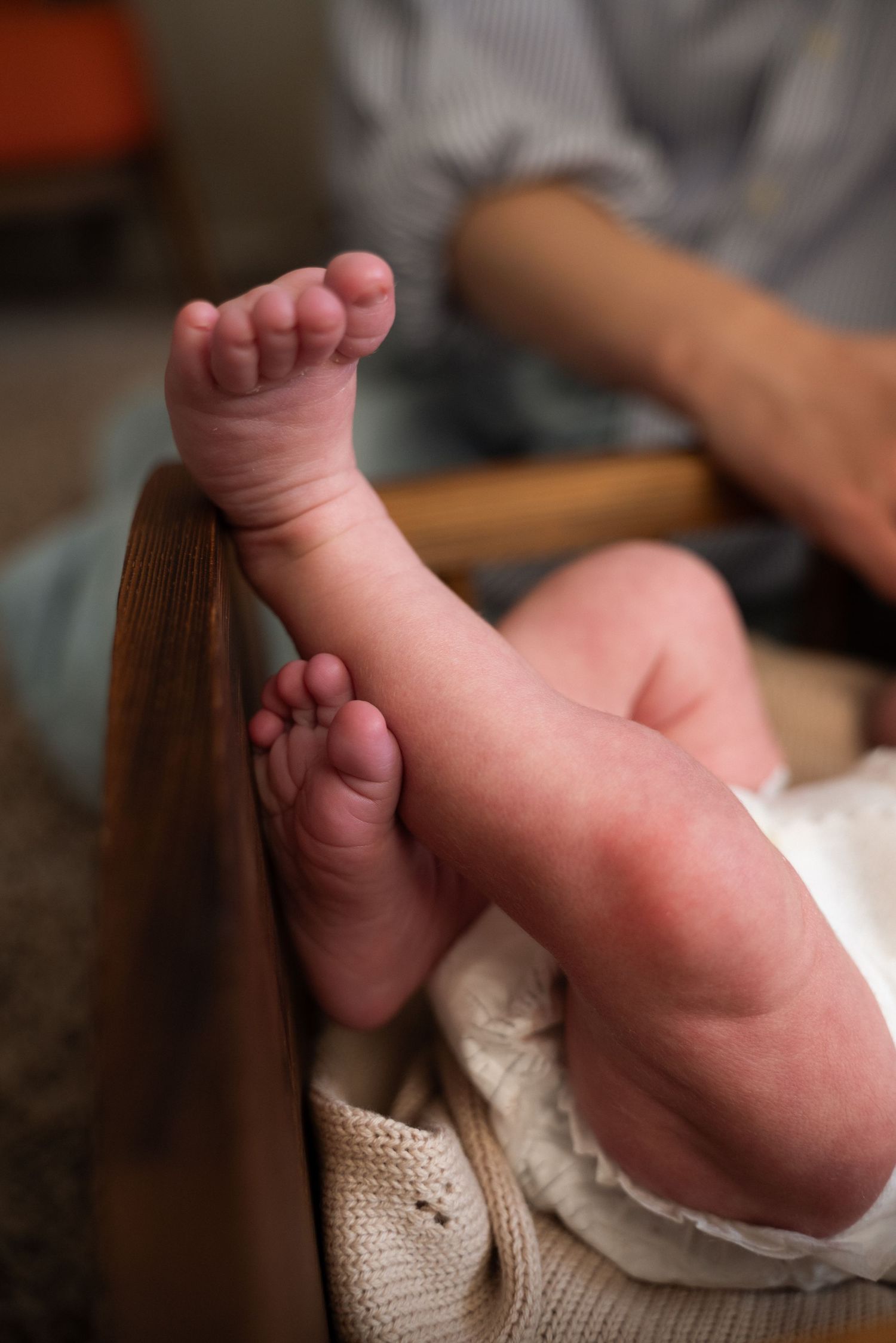 A series of close-up shots showing tiny baby feet against a soft white background.