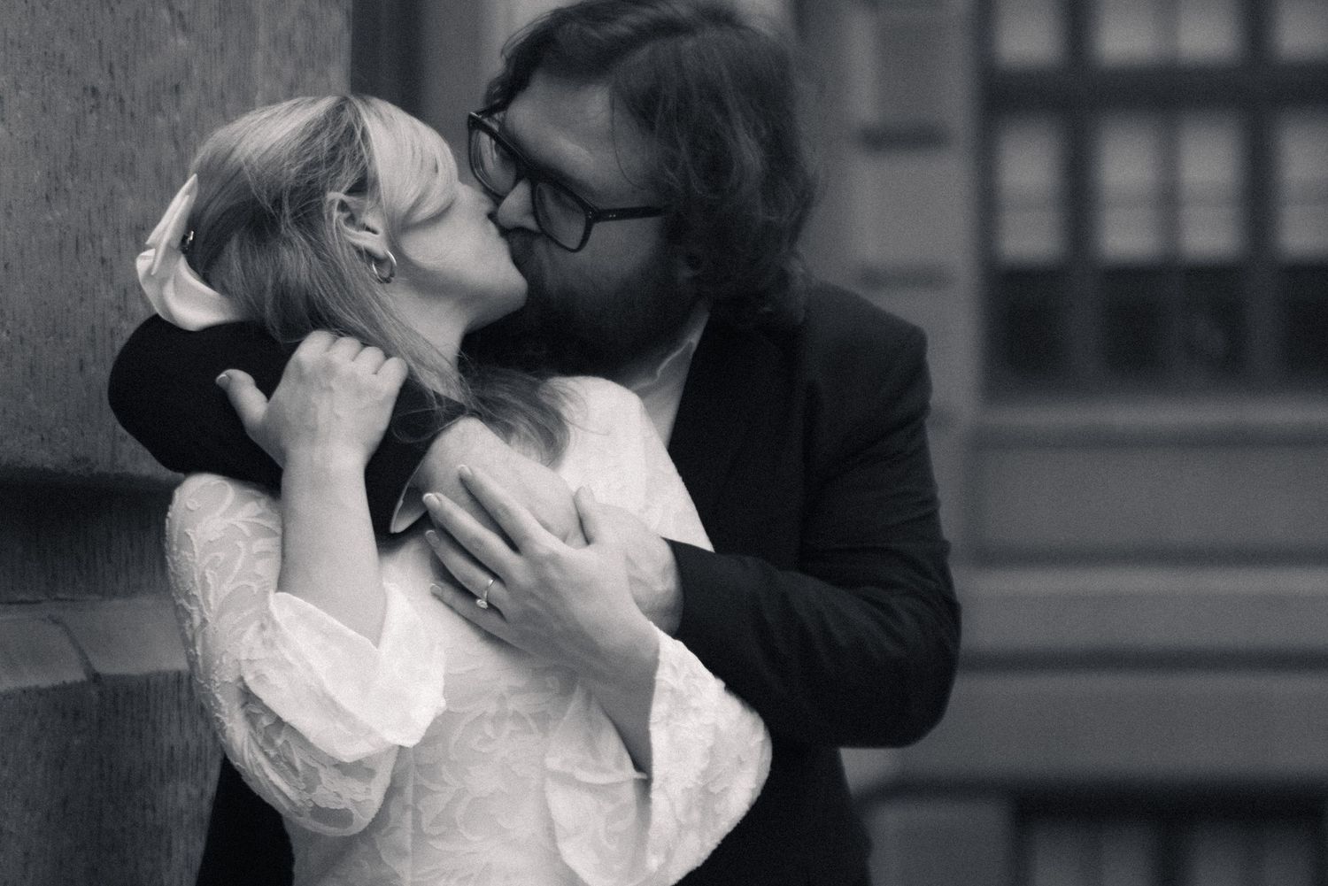 A series of black and white romantic photographs showing tender moments between a couple kissing and embracing.