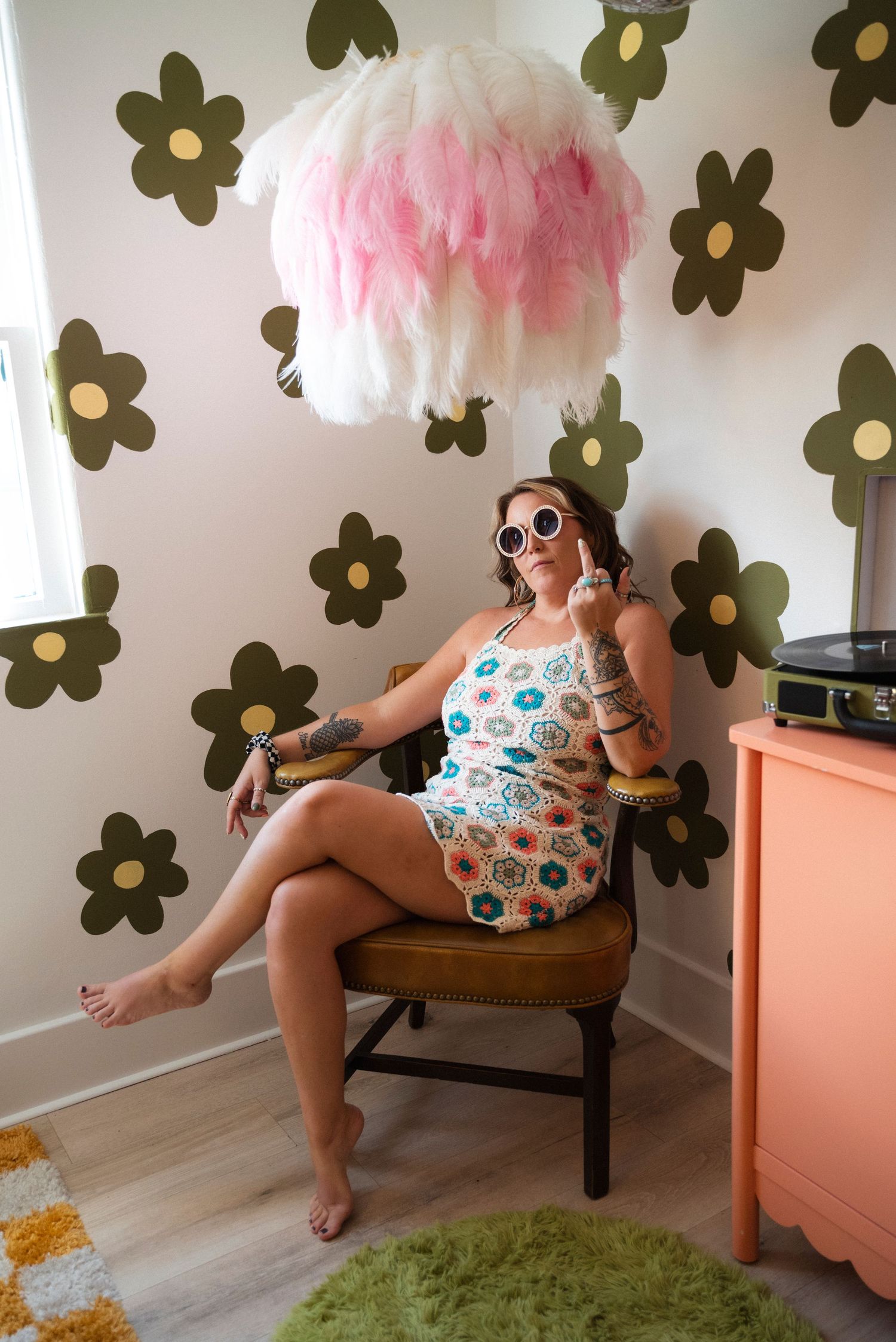 A set of four stylized photos showing someone in a patterned swimsuit and sunglasses lounging on a wooden bench against a floral wall.