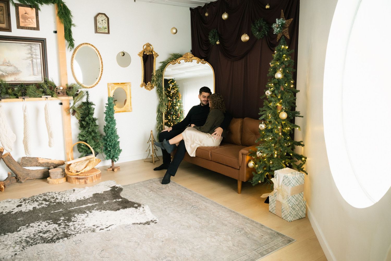 A bright white interior photo studio space with decorative plants, furniture, and natural lighting elements.