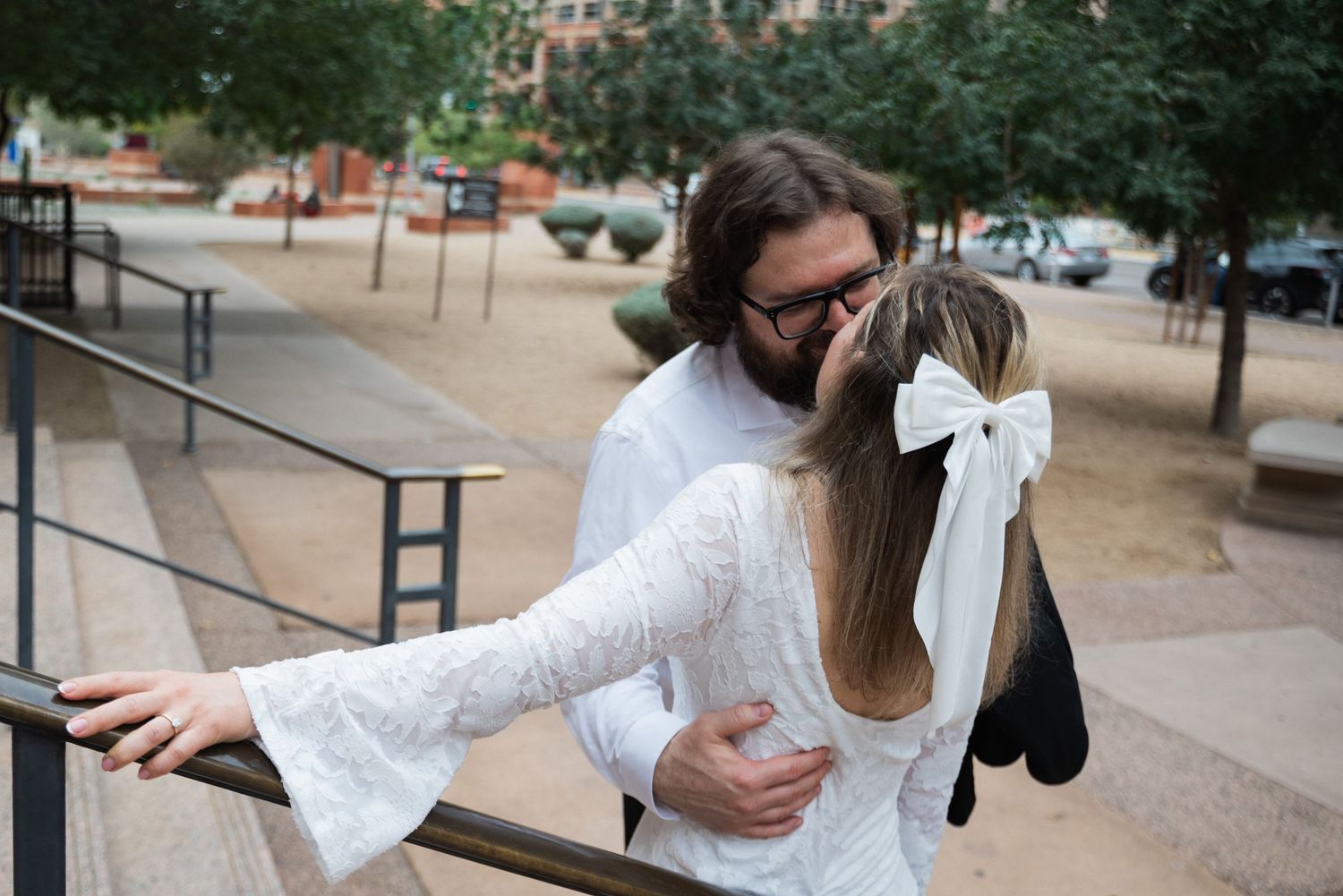 Collage of someone wearing a white lace dress being photographed outdoors in an urban setting.