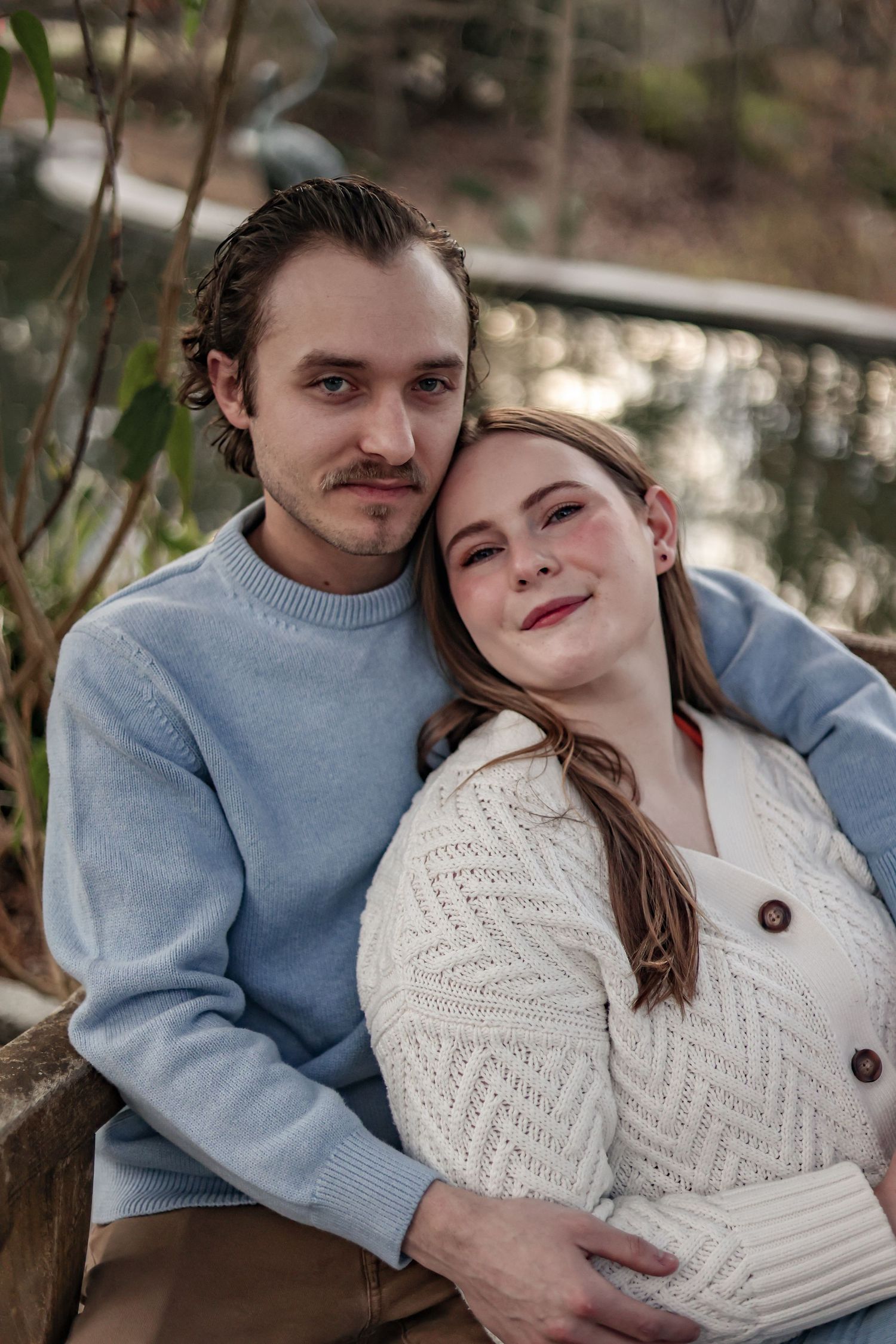 Close up portrait of couple wearing blue and white sweaters.