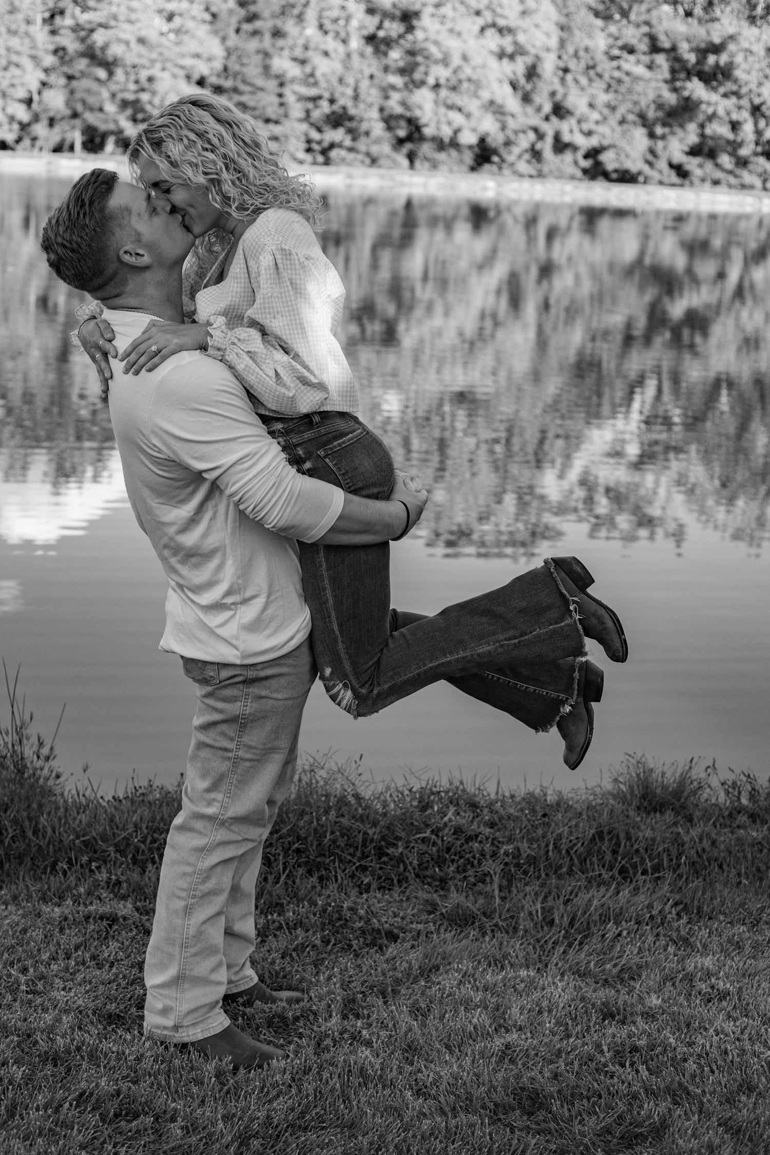 A romantic black and white photo sequence shows a couple embracing and spinning by a serene lakeside.