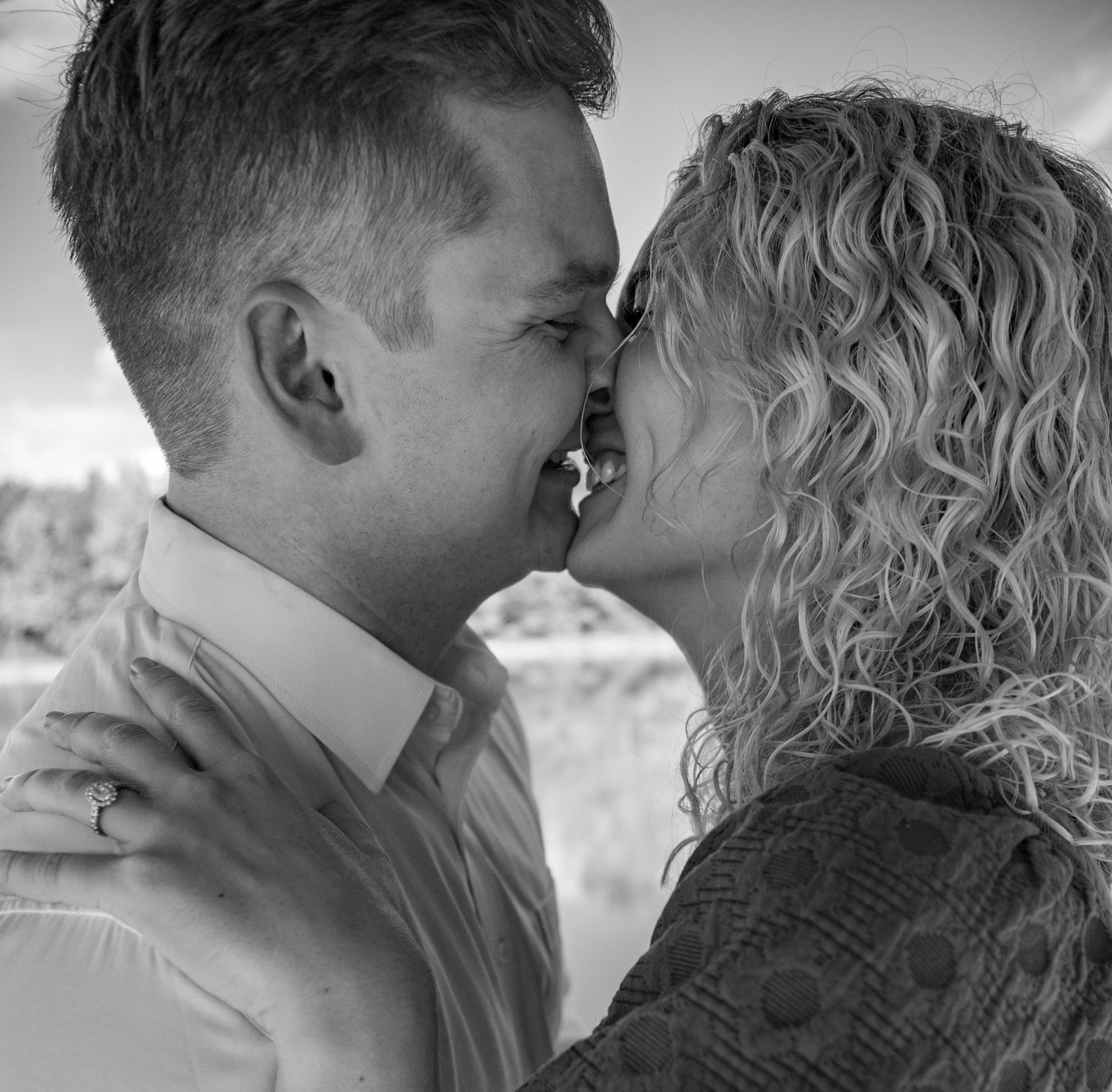 A romantic black and white photo series showing intimate kisses and tender moments between a couple.