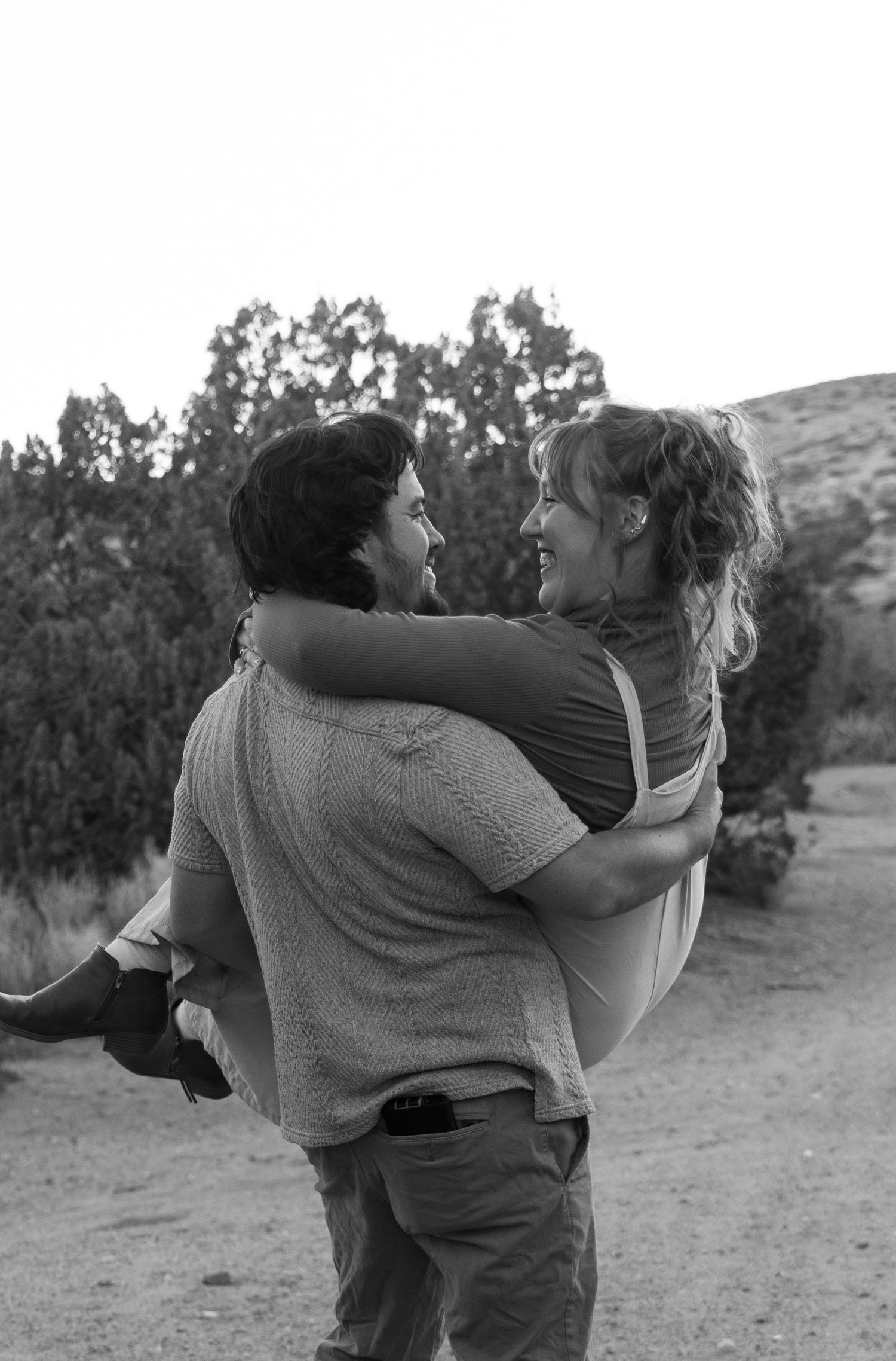 A black and white sequence showing a couple dancing and spinning together outdoors in a romantic embrace.