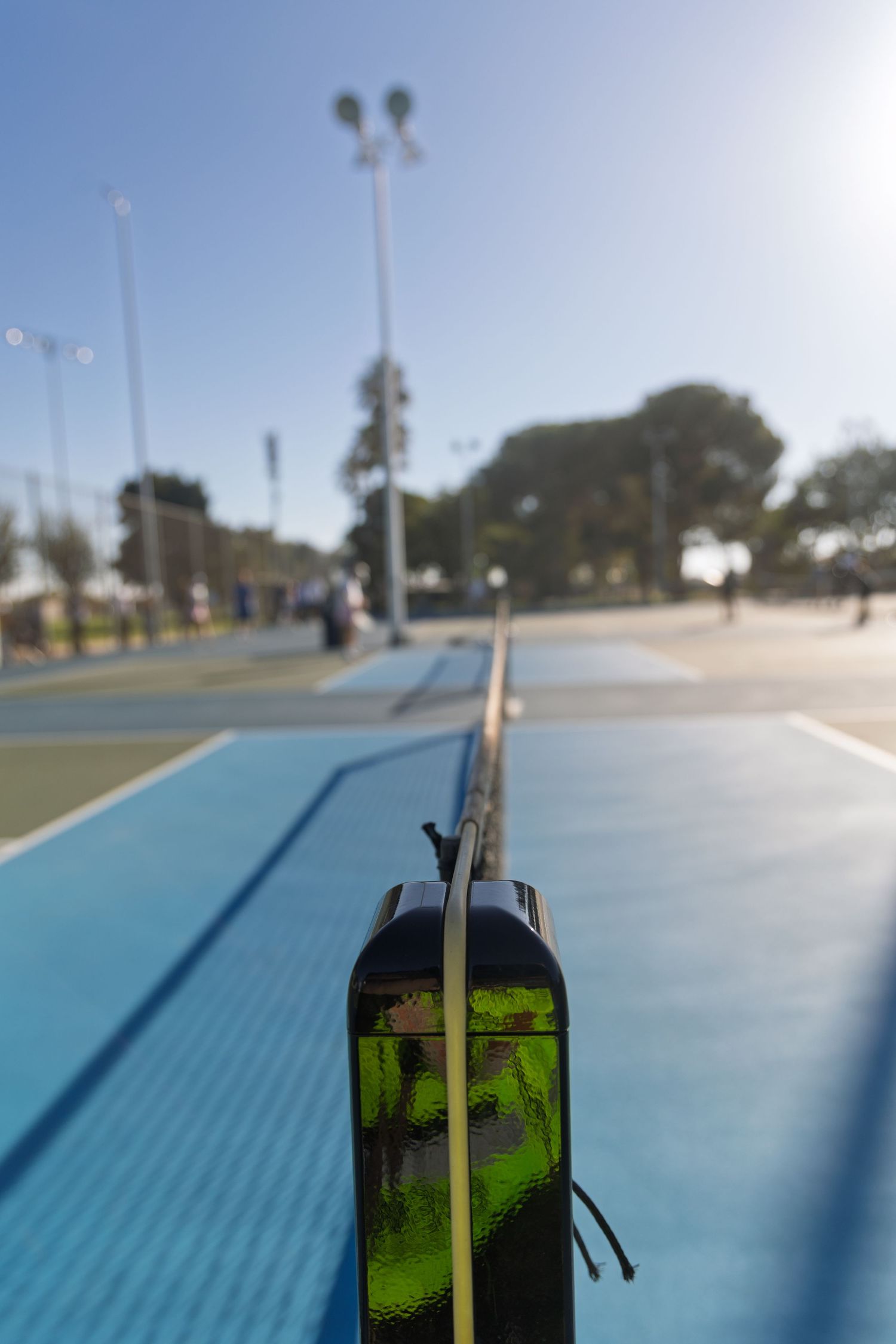 Close-up sequence of a blue skateboard ramp surface with a dark edge rail under bright sunlight.