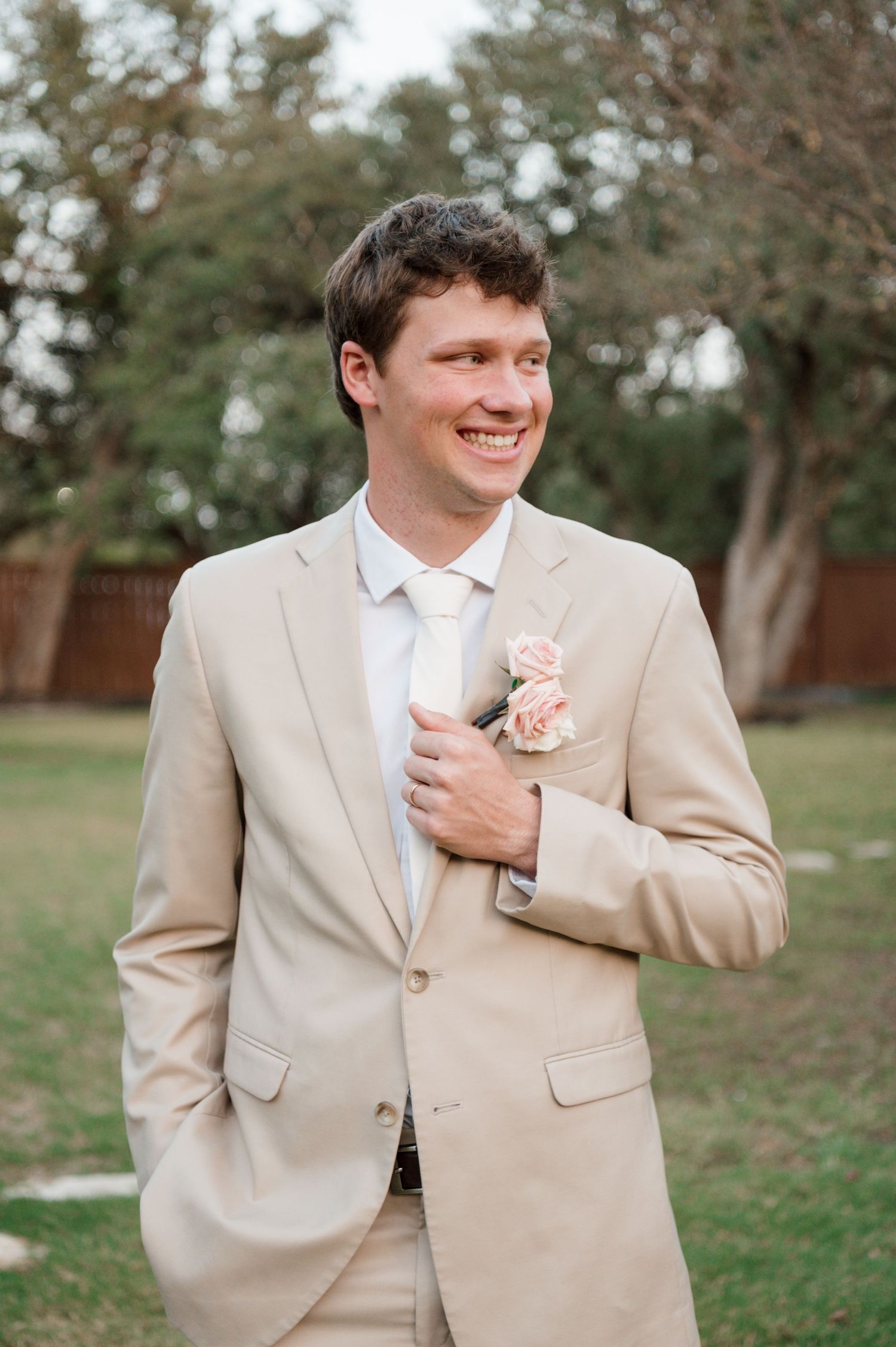 Groom in tan suit with boutonniere poses outdoors in multiple candid shots.