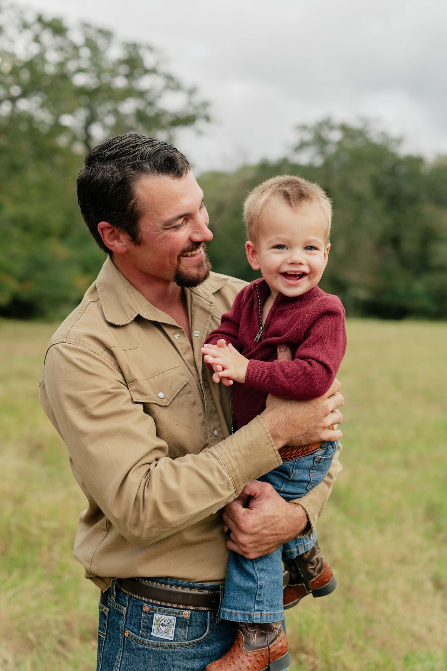 A heartwarming outdoor portrait of parent and child sharing laughter.