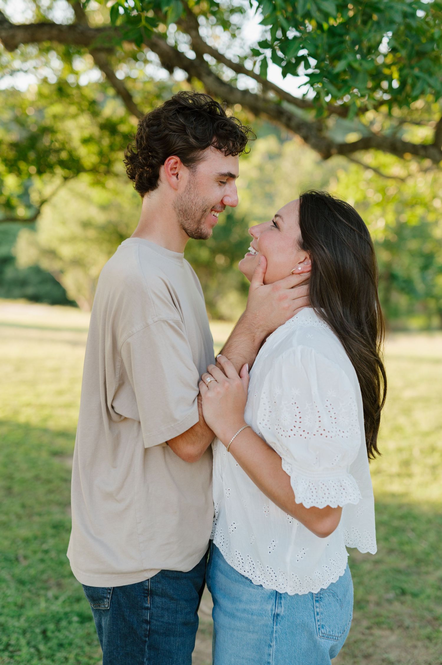 A playful couple sharing laughs during their casual outdoor photo session.
