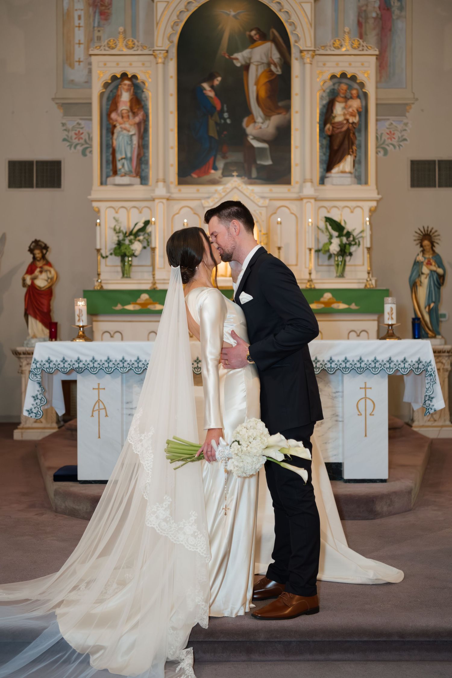 Wedding ceremony photos in an ornate Catholic church with traditional decorations and religious artwork.