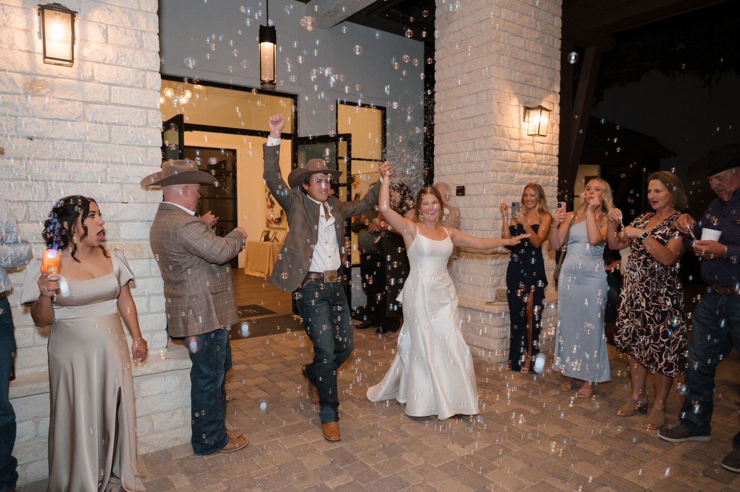 Wedding celebration with sparklers creating a magical nighttime exit scene.