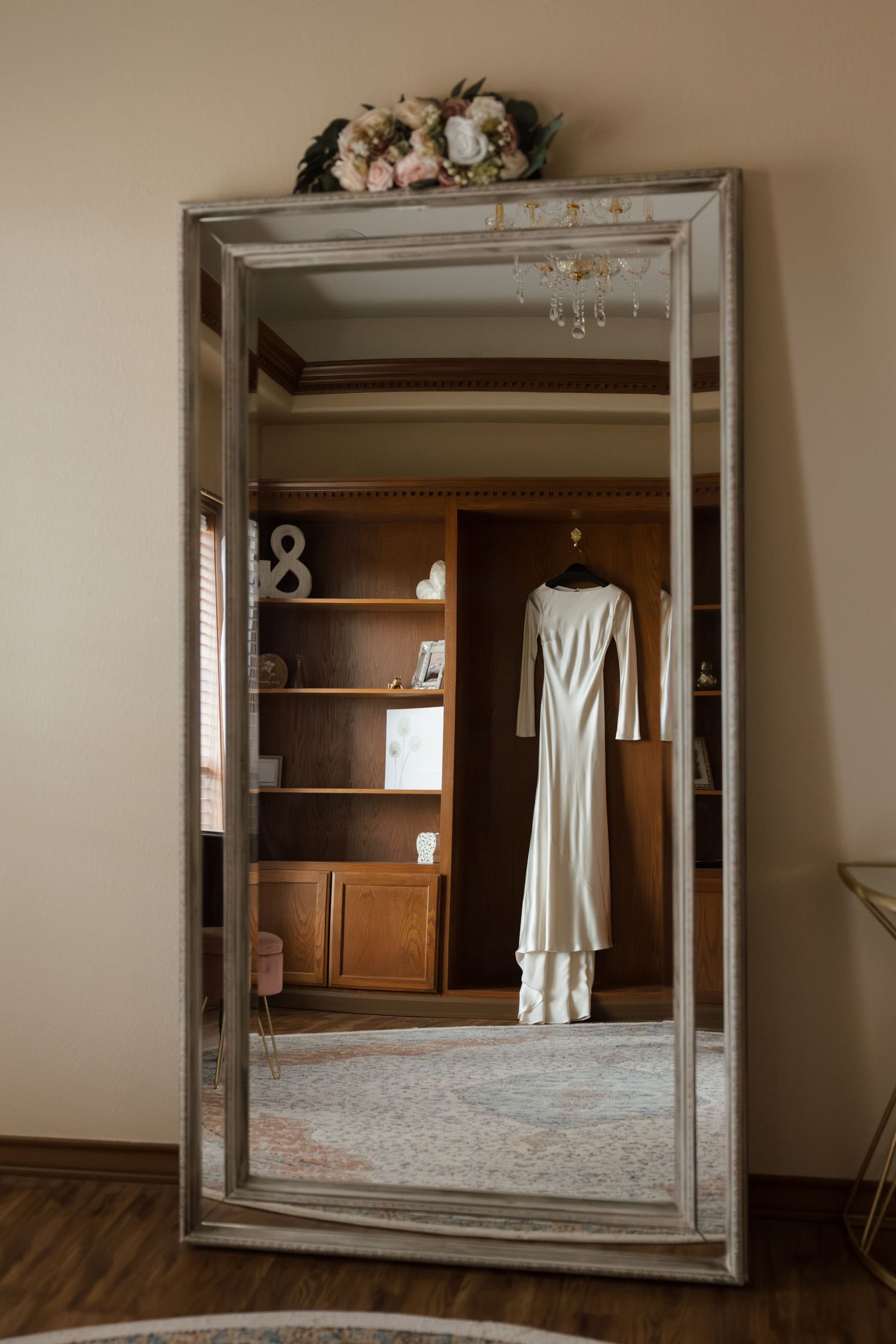 A series of framed mirror reflections showing a white wedding dress hanging in a wooden room interior.