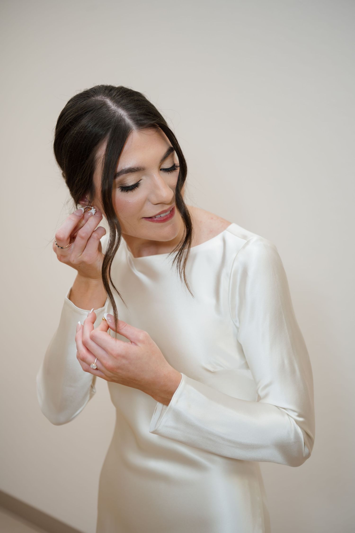 A sequence of candid shots showing a bride in a white long-sleeve dress posing playfully.