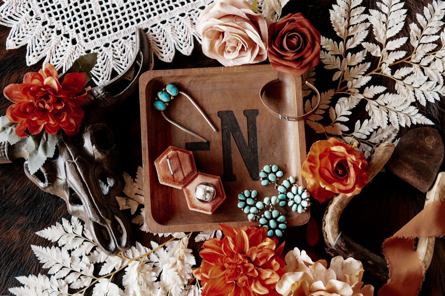Rustic wedding details featuring vintage box, floral arrangements and lace doily.