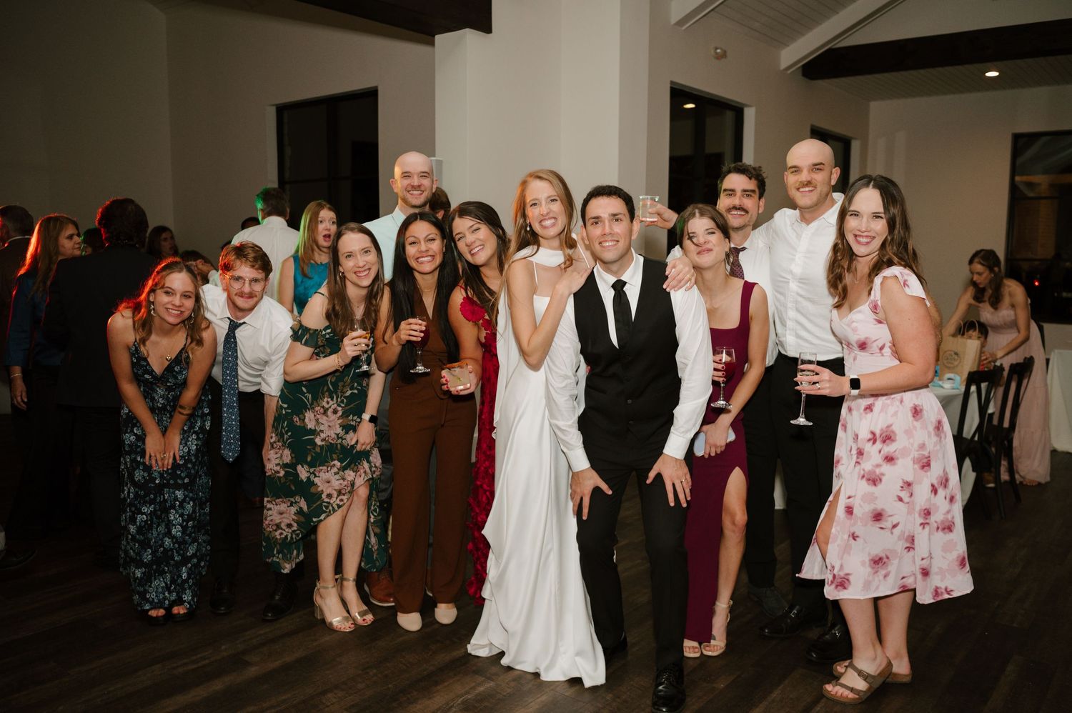 Wedding reception guests gather to watch the couple's first dance on the dance floor.