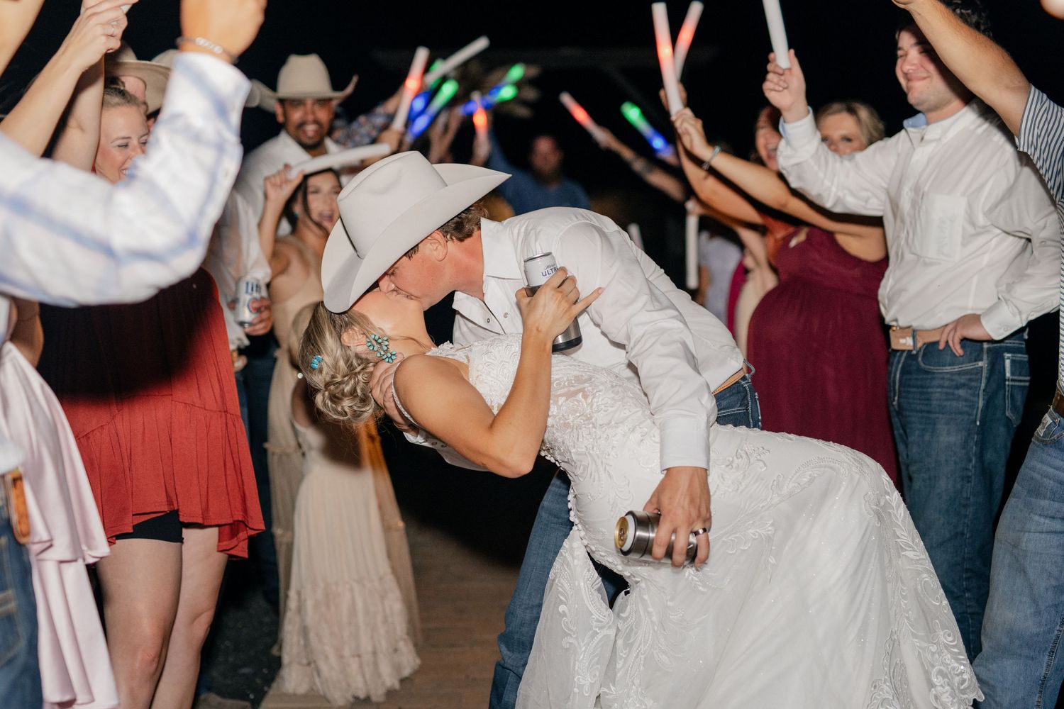 Wedding reception dance floor scene with celebratory party atmosphere and light sticks.