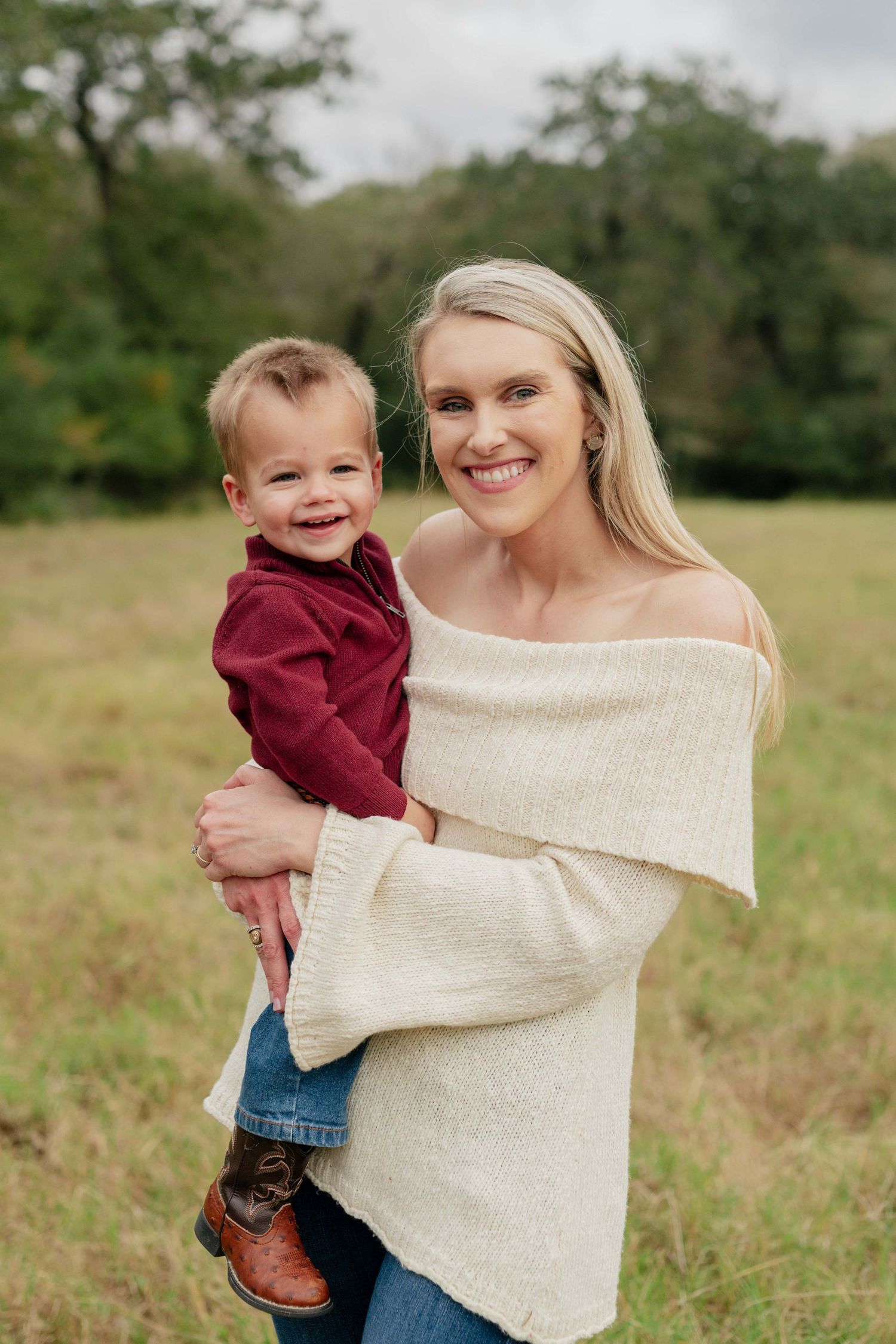 A joyful outdoor portrait of parent and child wearing casual attire.