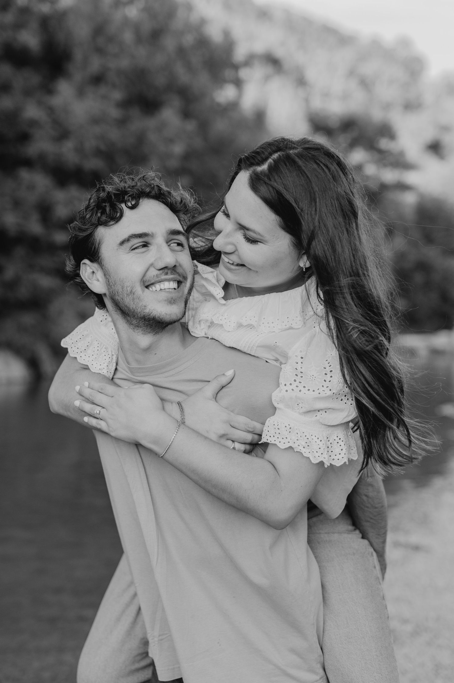 A romantic black and white photo series showing tender moments of affection between a couple outdoors.