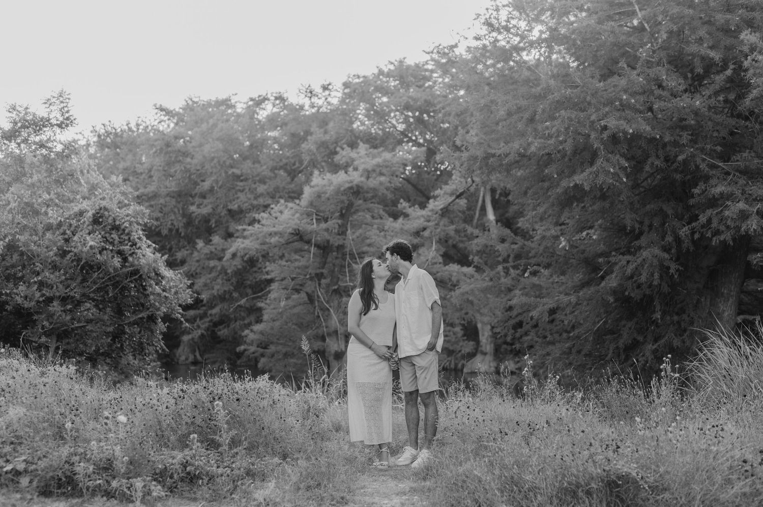 Black and white photo series of a couple posing together in a natural outdoor setting.