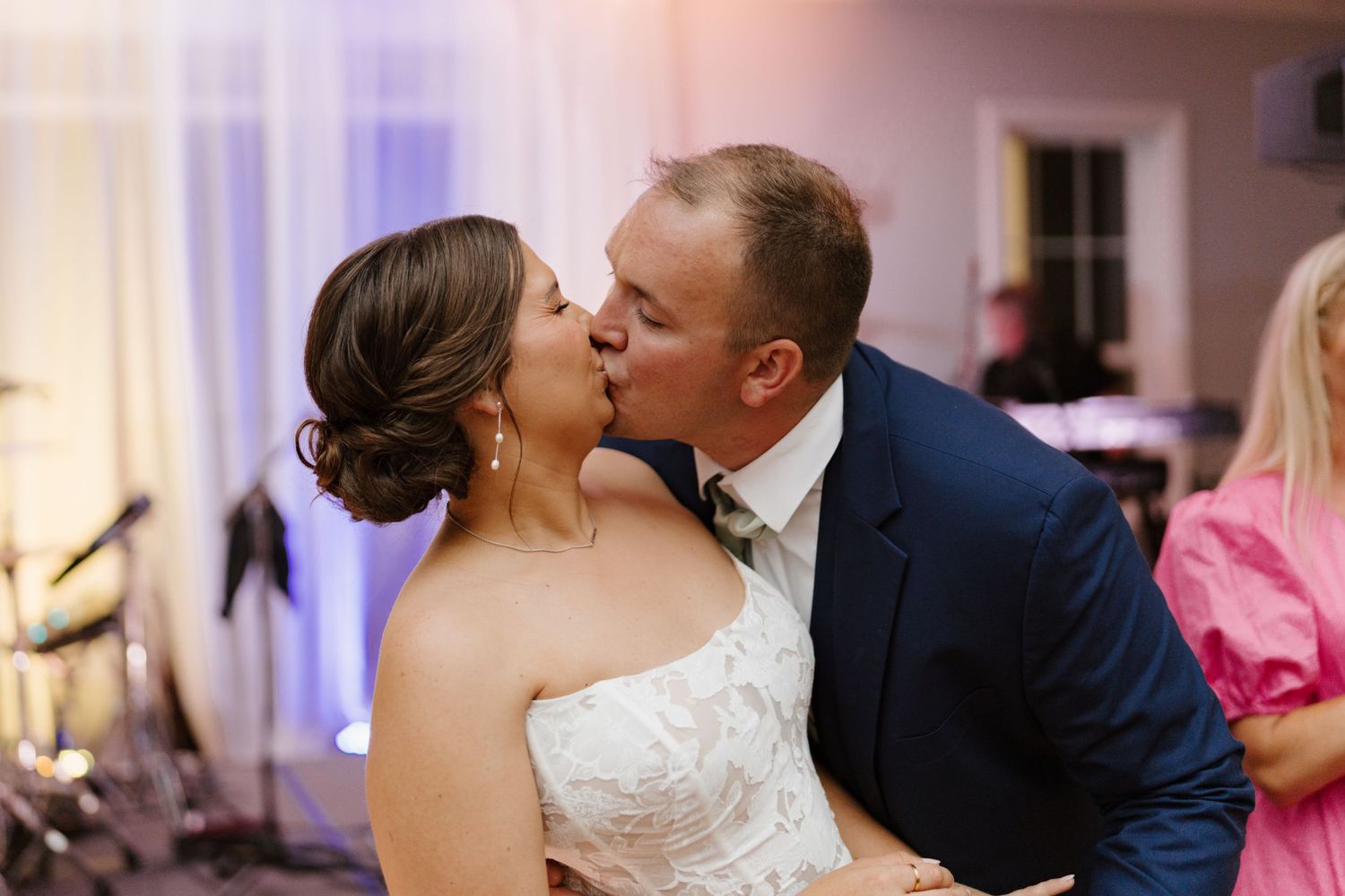 Romantic wedding couple sharing a kiss during their celebration.